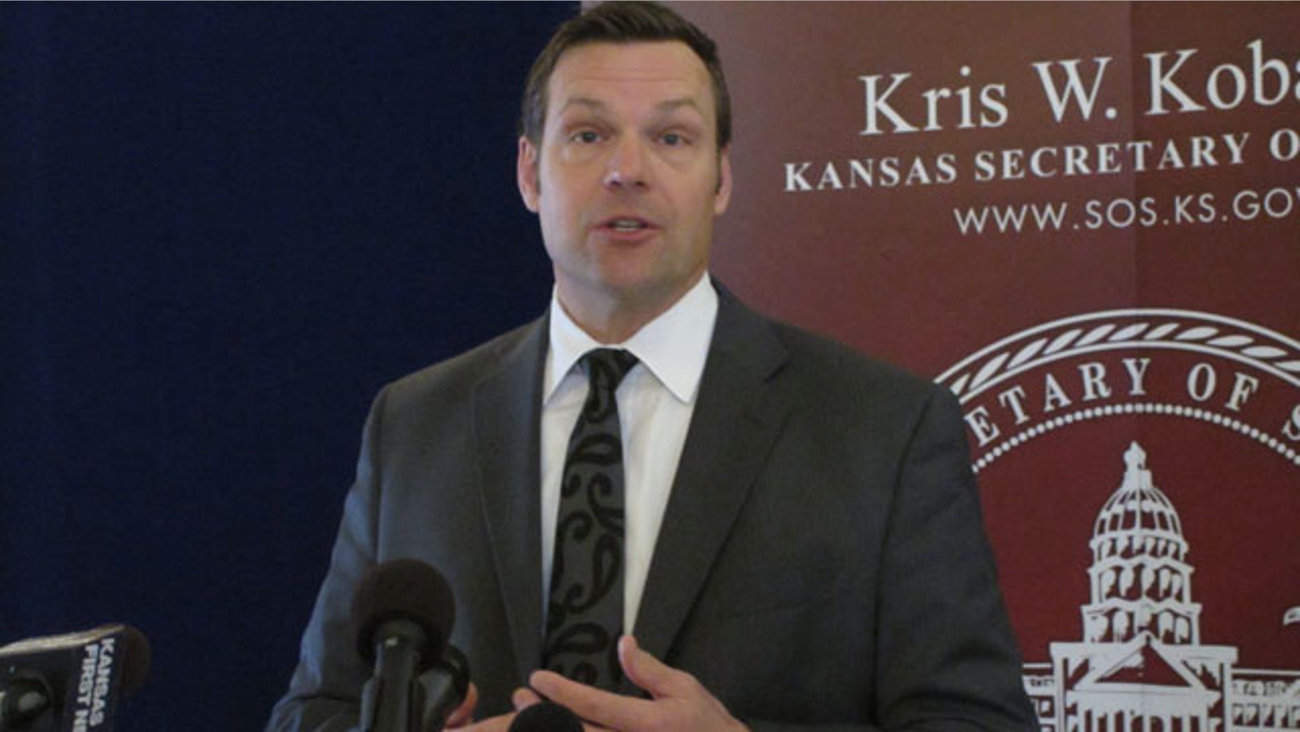 March 19, 2014: Kansas Secretary of State Kris Kobach discusses a federal judge's ruling ordering the federal government to help Kansas and Arizona enforce their proof-of-citizenship requirements for new voters. Kobach and Arizona Secretary of State Ken Bennett filed a lawsuit over the issue. (AP Photo/John Hanna)
