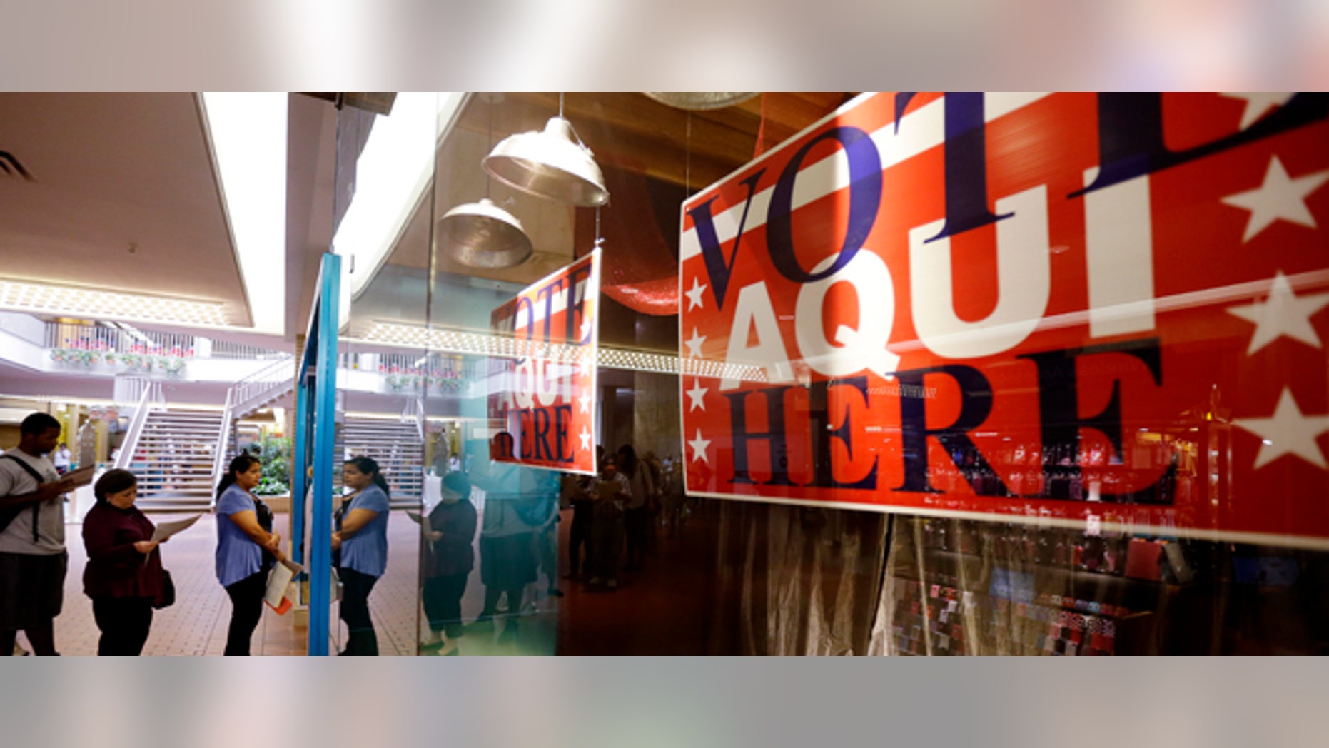 Voters wait in line at a polling place located inside a shopping mall on Election Day, 2012, in Austin, Texas.