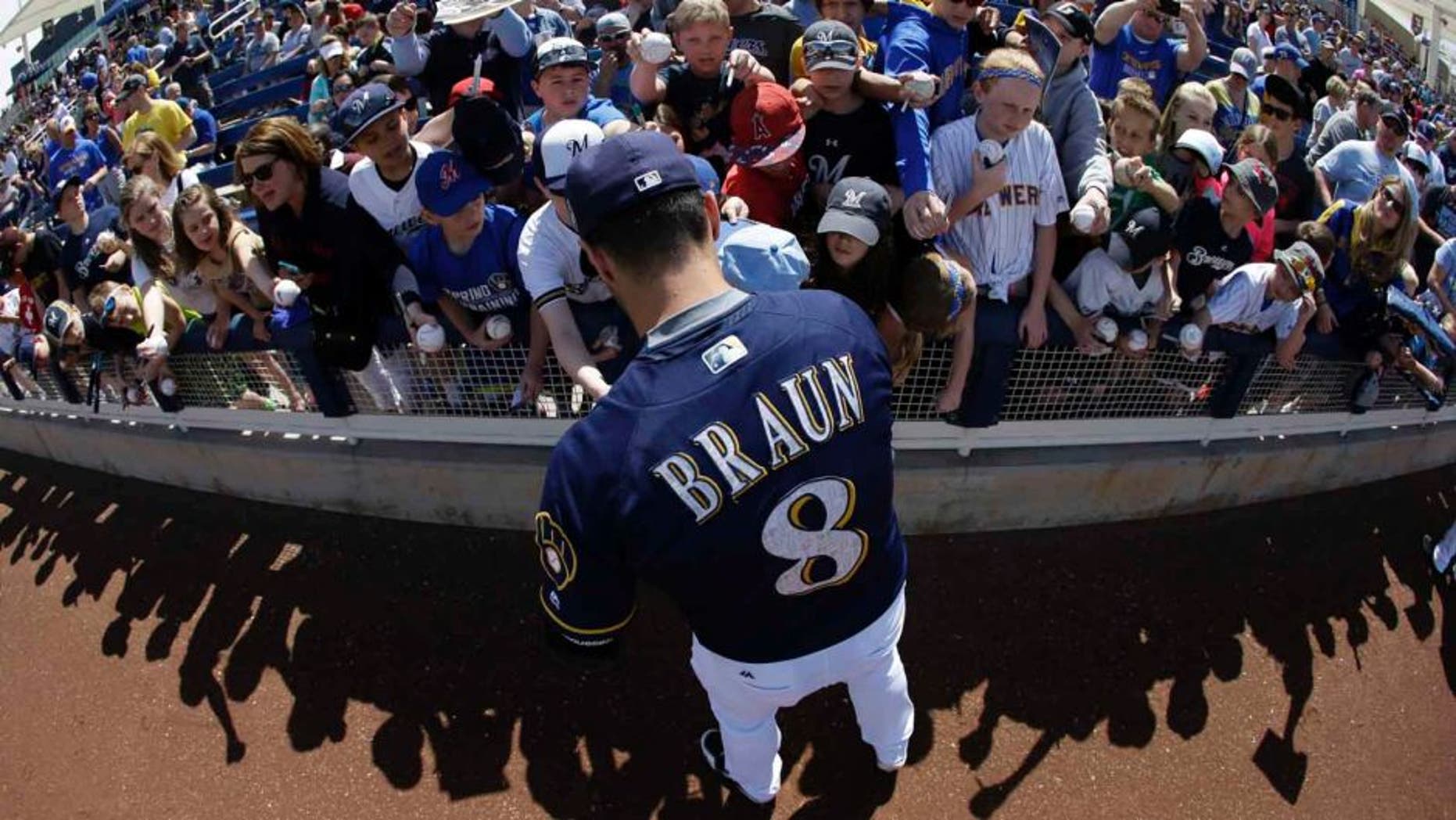 Tuesday, March 29: In this image taken with a fisheye lens, the Milwaukee Brewers' Ryan Braun signs autographs for fans before a spring training game against the Cincinnati Reds in Phoenix.