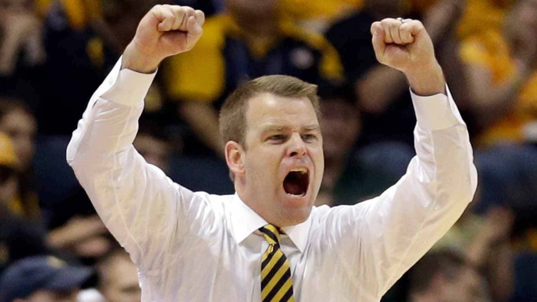 Marquette head coach Steve Wojciechowski shouts during the second half of an NCAA college basketball game against Morgan State Sunday, Dec. 28, 2014, in Milwaukee. (AP Photo/Aaron Gash)