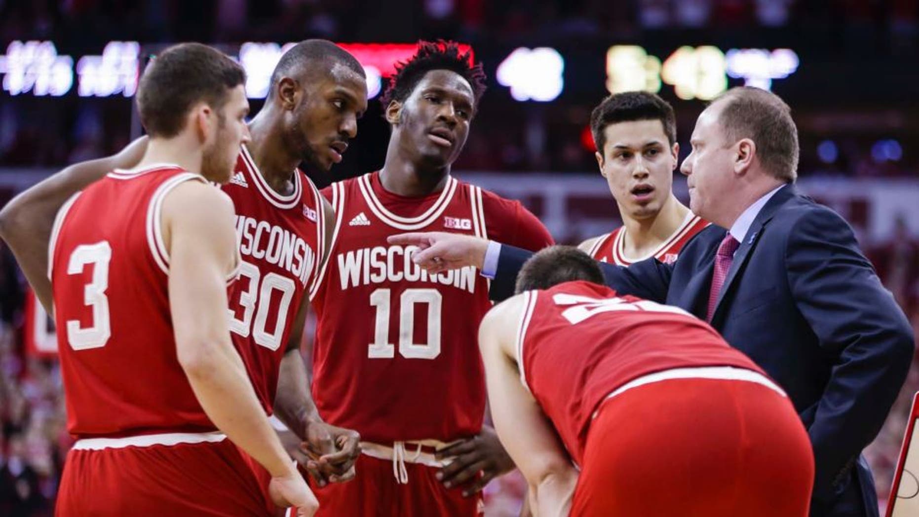 Sunday, Feb. 21: Wisconsin interim head coach Greg Gard (right) talks with (from left to right) Zak Showalter, Vitto Brown, Nigel Hayes, Bronson Koenig and Ethan Happ (bent over) during the second half against Illinois. Wisconsin won 69-60.