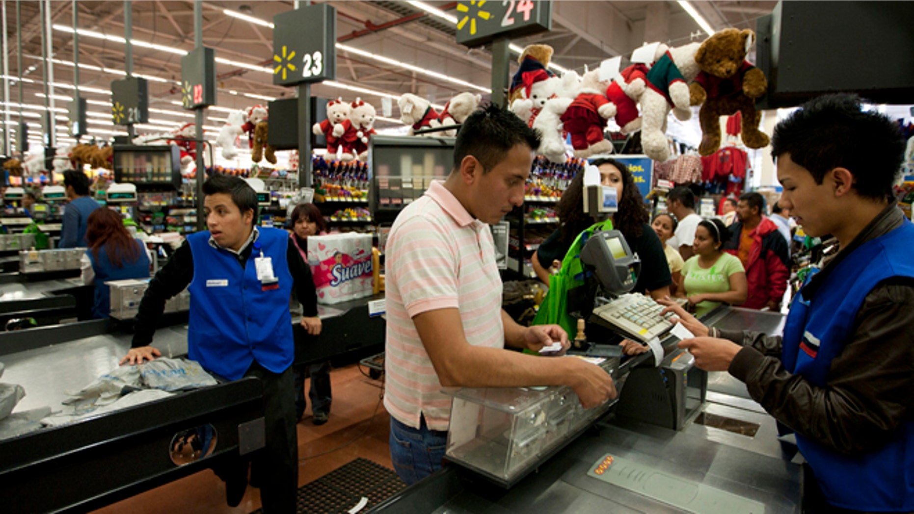 FILE - In this Nov. 18, 2011 file photo, a man pays at the cash register at a Wal-Mart Superstore in Mexico City. Lawmakers are making public emails that show that Wal-Mart Stores Inc.'s CEO found out in 2005 that the retailer was handing out bribes in Mexico. (AP Photo)