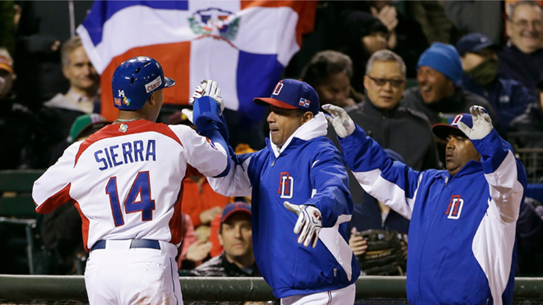 Dominican Republic's Moises Sierra (14) celebrates after scoring during the fifth inning of a semifinal game of the World Baseball Classic against the Netherlands in San Francisco, Monday, March 18, 2013. (AP Photo/Eric Risberg)