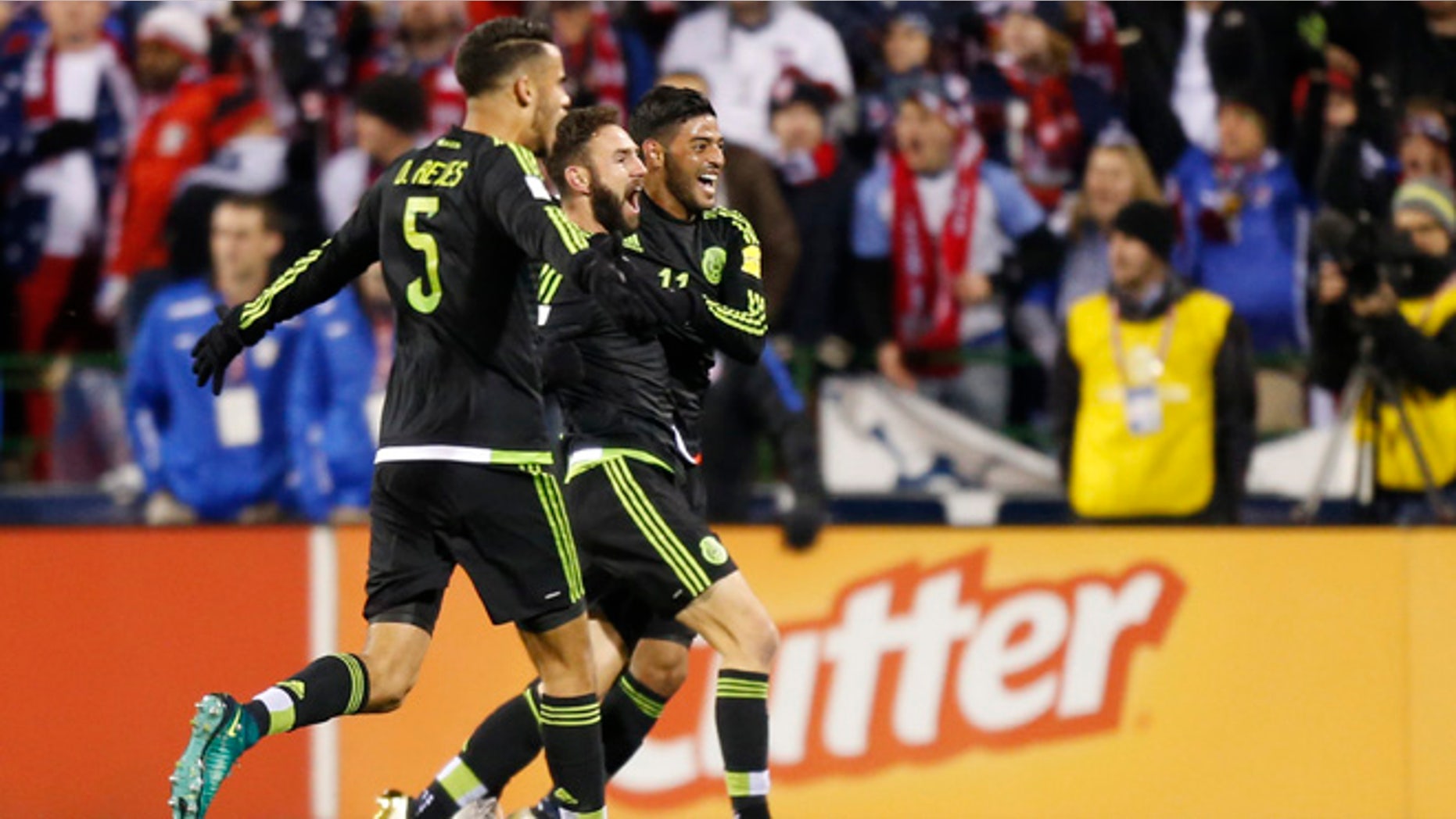 From left to right, Mexico's Diego Reyes, Miguel Layun and Carlos Vela celebrate their goal against the United States during the first half of a World Cup qualifying soccer match Friday, Nov. 11, 2016, in Columbus, Ohio. (AP Photo/Jay LaPrete)