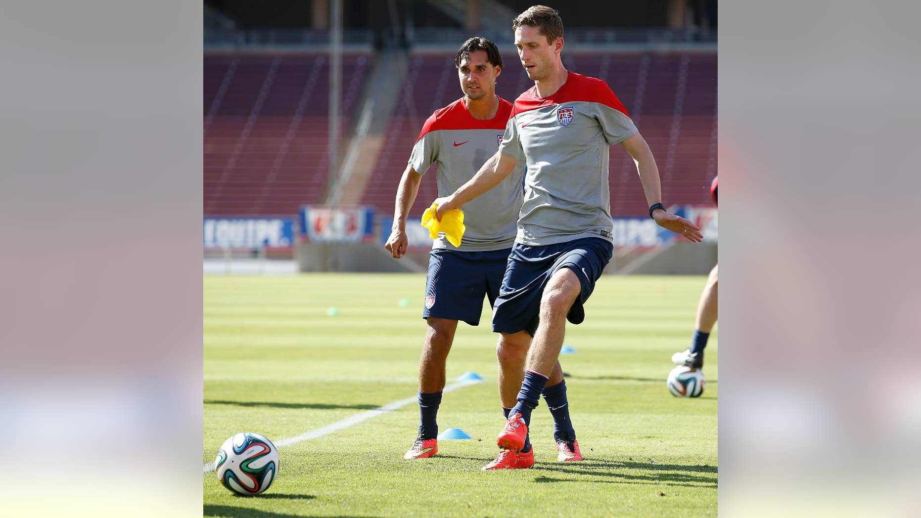 United States' Clarence Goodson, right, controls the ball next to teammate Chris Wondolowski during a training session Wednesday, May 14, 2014, in Stanford, Calif. The team began a two-week training camp leading up to a May 27 exhibition with Azerbaijan at San Francisco's Candlestick Park. (AP Photo/Tony Avelar)