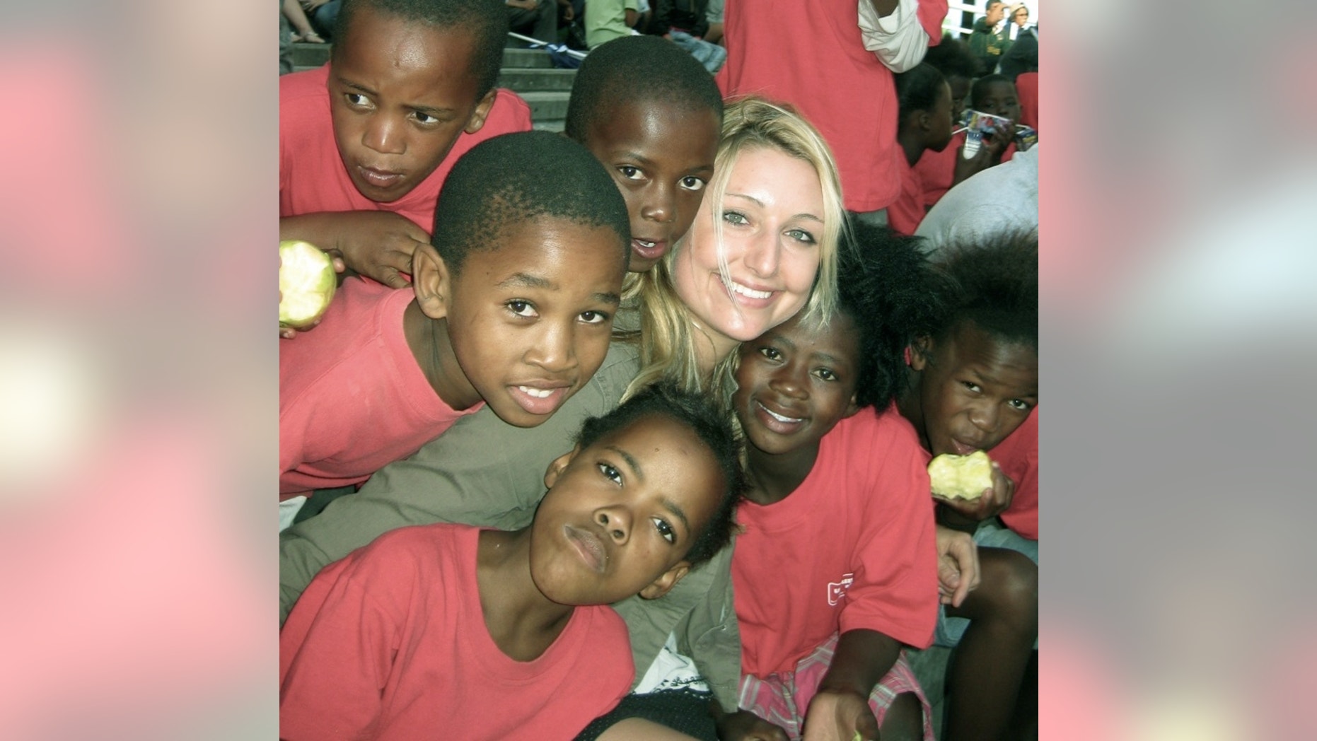 Whitney Johnson, surrounded by the children of Ubuntu.