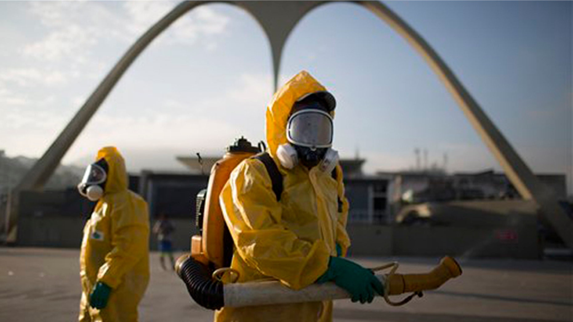 FILE - In this Tuesday, Jan. 26, 2016 file photo, a health workers stands in the Sambadrome spraying insecticide to combat the Aedes aegypti mosquito that transmits the Zika virus in Rio de Janeiro, Brazil. The Sambadrome will be used for the Archery competition during the 2016 summer games. With the opening ceremony less than three months away, a Canadian professor has called for the Rio Olympics to be postponed or moved because of the Zika outbreak, warning the influx of visitors to Brazil will result in the avoidable birth of malformed babies. The IOC and World Health Organization disagree, saying Zika will not derail the games. (AP Photo/Leo Correa, File)