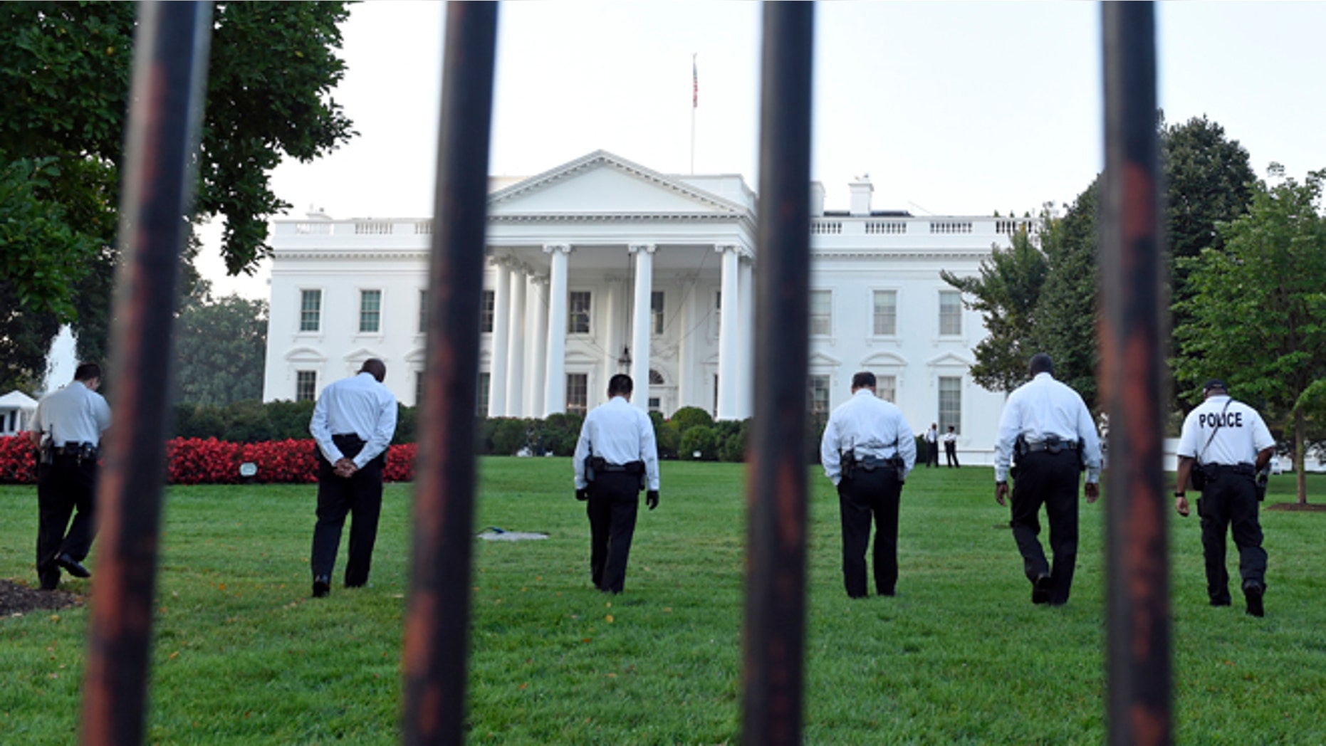 Sept. 20, 2014: Uniformed Secret Service officers walk along the lawn on the North side of the White House in Washington, D.C.