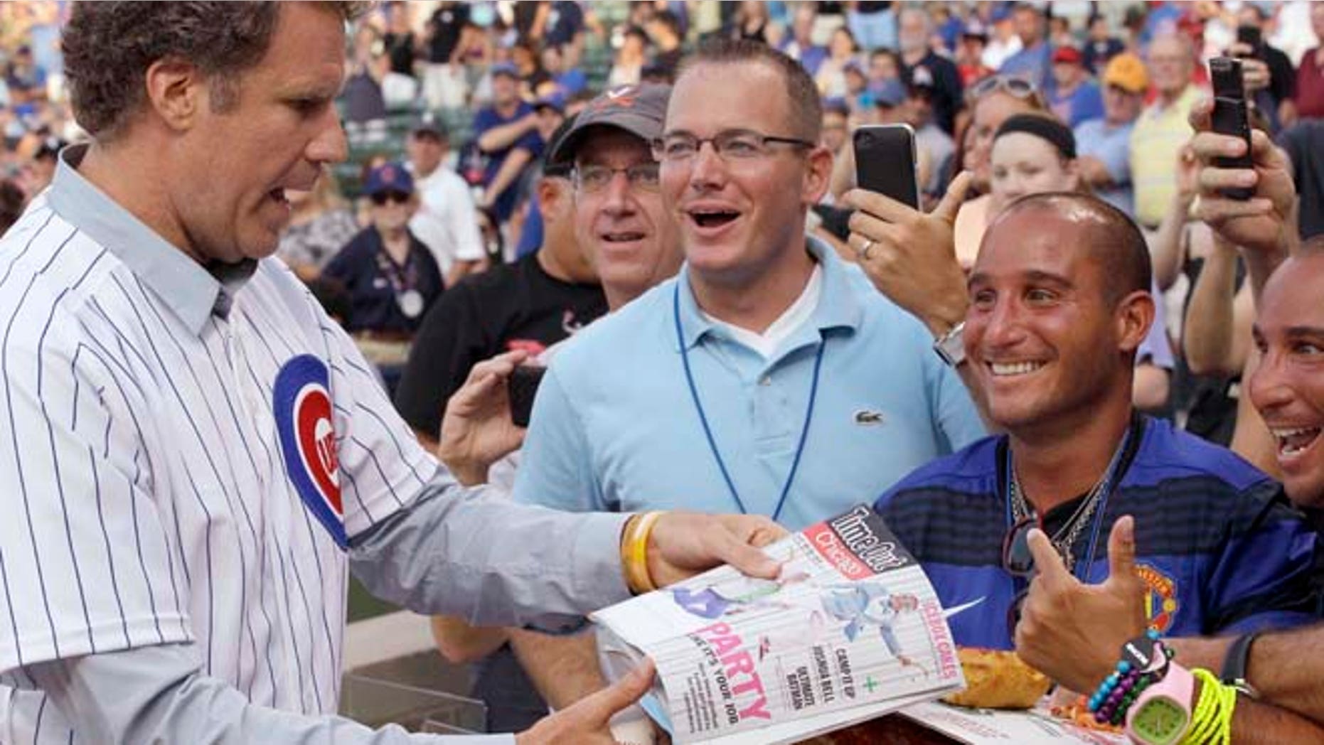 FILE - Will Ferrell, left, talks with fans after throwing out the ceremonial first pitch before a baseball game between the Miami Marlins and the Chicago Cubs in Chicago.