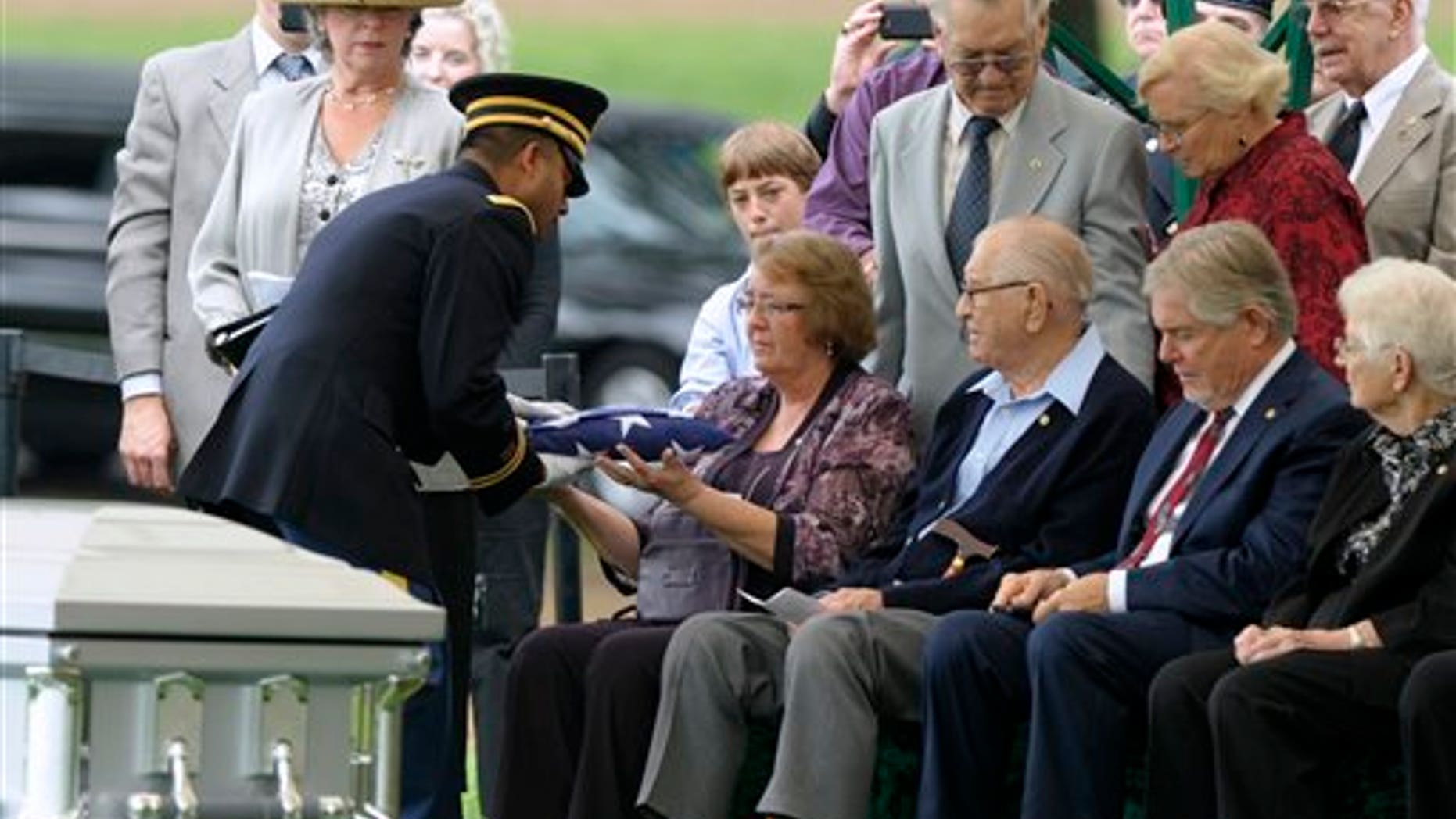 September 21: Bonnie Williams, daughter of Tech Sgt. Robert L. Christopherson, receives a flag from Army Chaplain John Gabriel during a during a burial ceremony for nine WW II Army Airmen at Arlington National Cemetery in Arlington, Va.