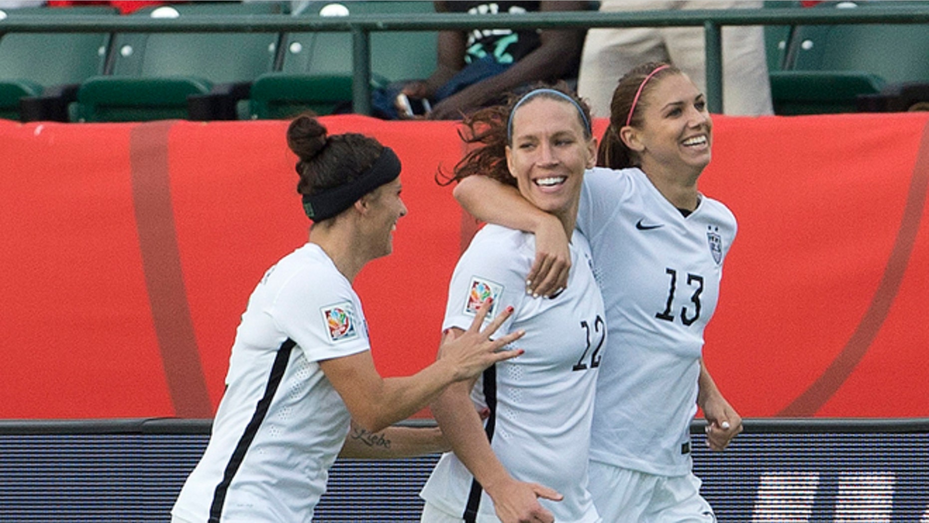 United States' Ali Krieger (11), Lauren Holiday (12) and Alex Morgan (13) celebrate a goal against Colombia during second half FIFA Women's World Cup round of 16 soccer action in Edmonton, Alberta, Canada, Monday, June 22, 2015. (Jason Franson/The Canadian Press via AP) MANDATORY CREDIT