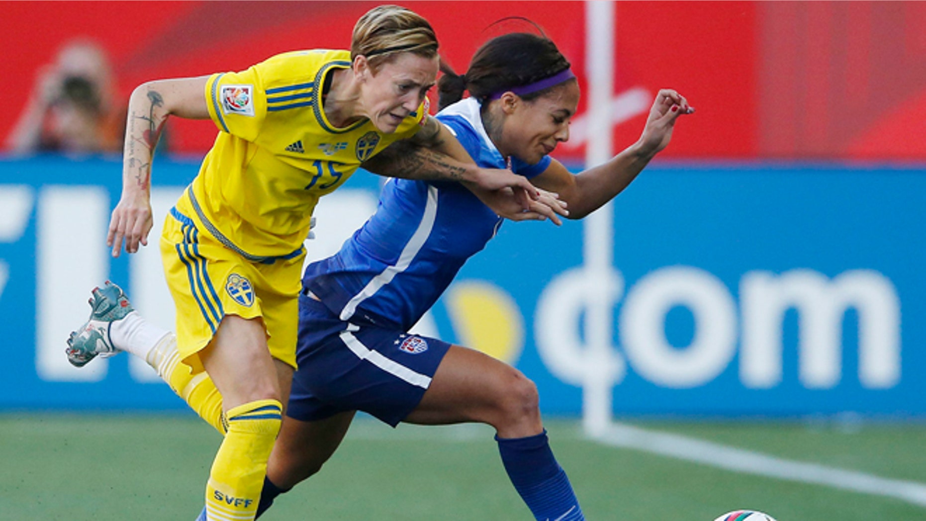 Sweden's Therese Sjogran (15) and United States' Sydney Leroux chase down the ball during first-half FIFA Women's World Cup soccer game action in Winnipeg, Manitoba, Canada, Friday, June 12, 2015. (John Woods/The Canadian Press via AP) MANDATORY CREDIT