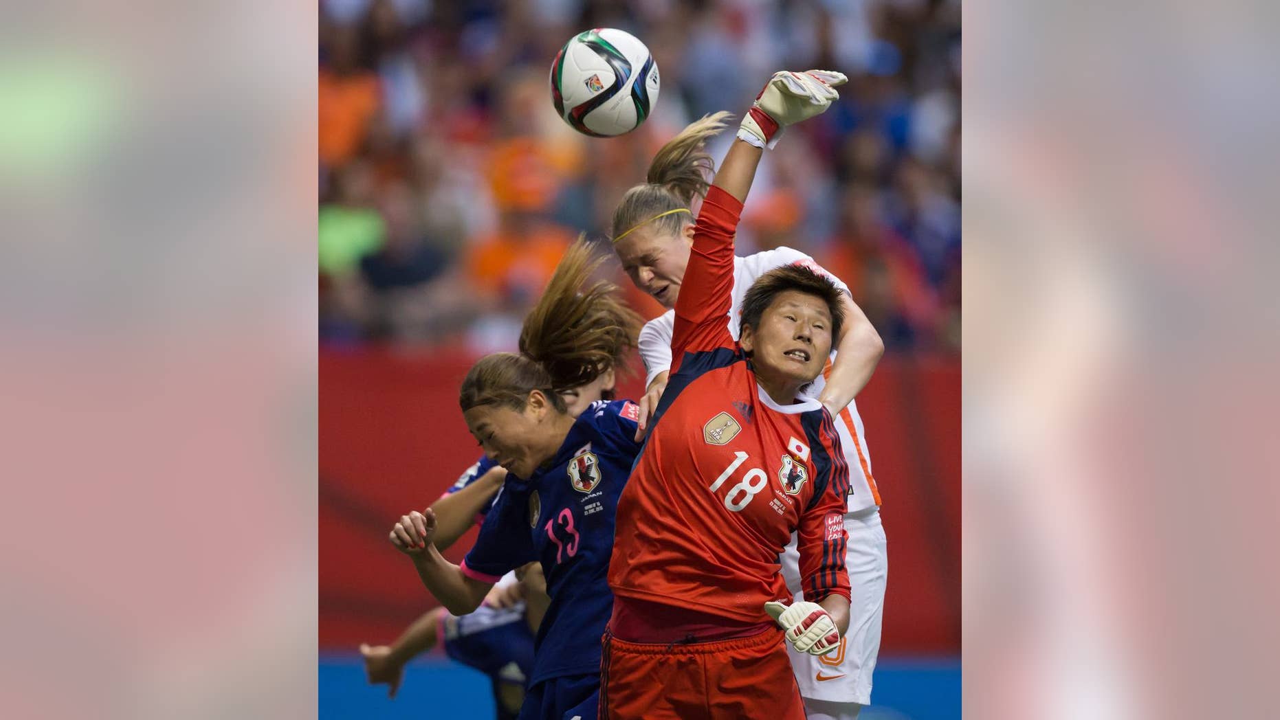 Netherlands' Anouk Dekker, back right, gets her head on the ball but fails to score as Japan goalkeeper Ayumi Kaihori (18) reaches for the ball and Rumi Utsugi (13) defends during the second half of a round of 16 soccer match at the FIFA Women's World Cup, Tuesday, June 23, 2015, in Vancouver, British Columbia, Canada. (Darryl Dyck/The Canadian Press via AP)