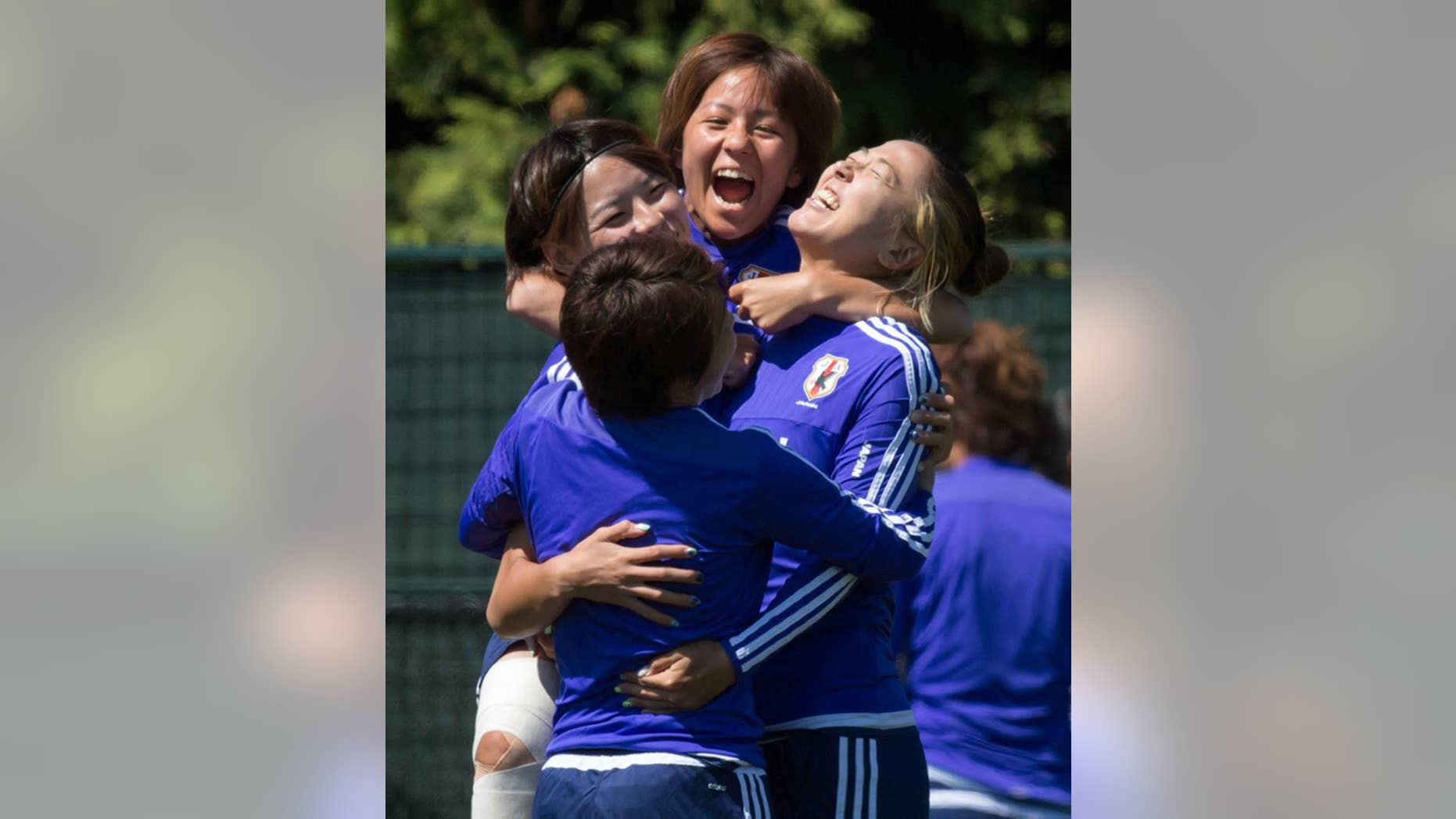 Japan's Mana Iwabuchi, back, jumps onto teammates Aya Sameshima, back left, Yuki Ogimi, right, and Aya Miyama, front, during a practice session in Vancouver, British Columbia, in Canada, on Saturday, July 4, 2015. Japan and the United States are scheduled to play in the final of the FIFA Women's World Cup soccer tournament on Sunday in Vancouver. (Darryl Dyck/The Canadian Press via AP) MANDATORY CREDIT