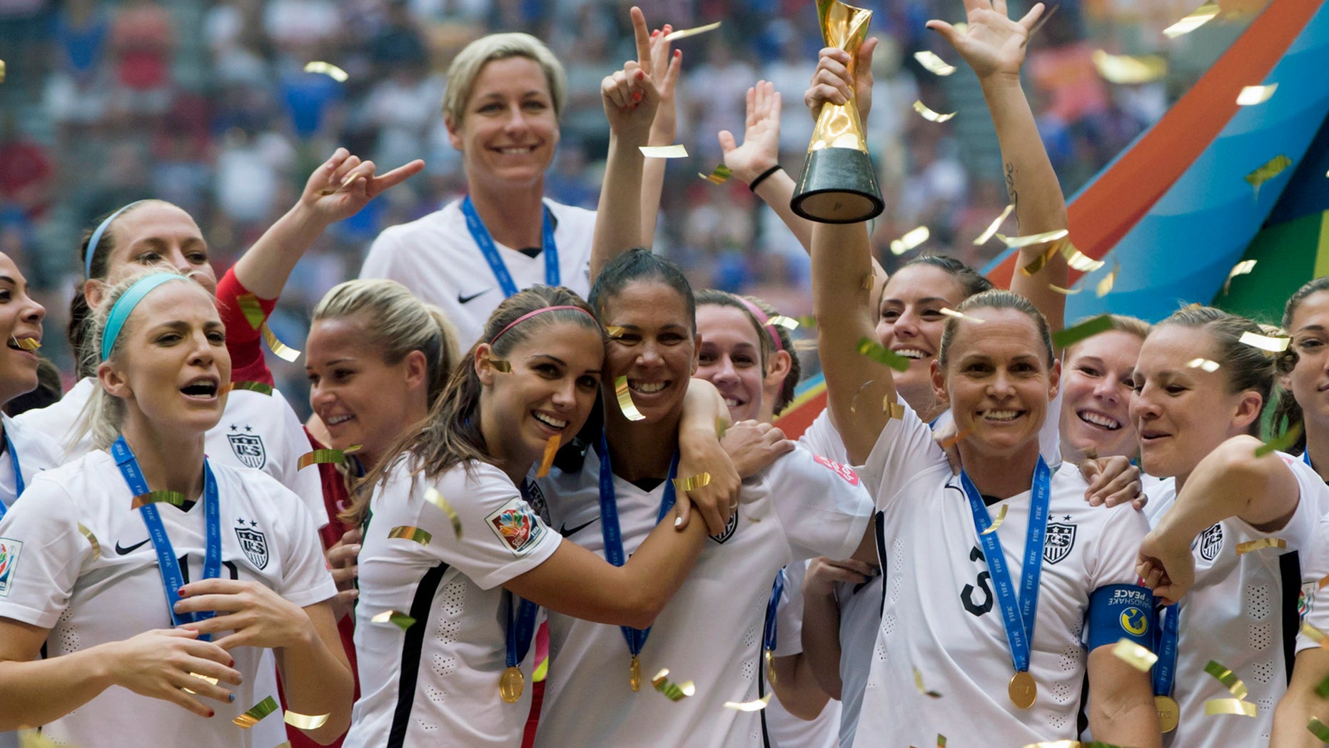 The United States Women's National Team celebrates with the trophy after they defeated Japan 5-2 in the FIFA Women's World Cup soccer championship in Vancouver, British Columbia, Canada, Sunday, July 5, 2015. (Darryl Dyck/The Canadian Press via AP) MANDATORY CREDIT