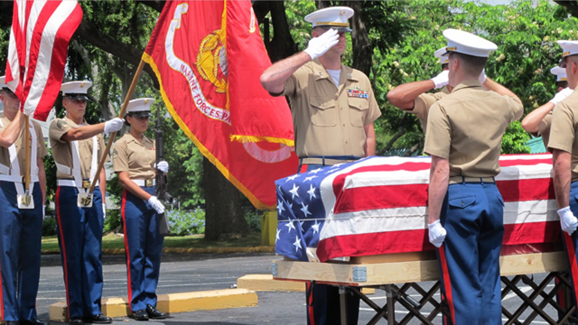 Sept. 24, 2015: United States Marines salute during a ceremony in Honolulu for the departure of 1st Lt. Alexander Bonnyman's remains. (AP Photo/Audrey McAvoy)