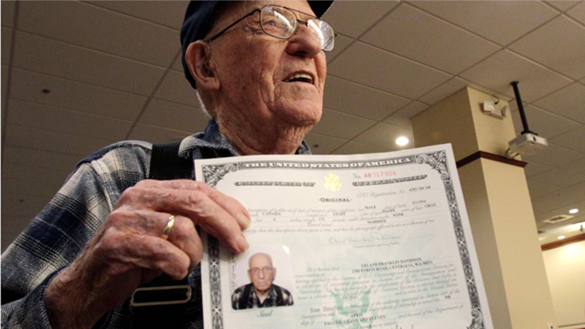 April 5, 2011: Leland Davidson, 95, of Centralia, Wash., displays his certificate of citizenship after he took part in a ceremony to award his certificate of U.S. citizenship in Seattle. Leland was born in Canada to parents who were both citizens, but until now, his U.S. citizenship had not been formally documented.
