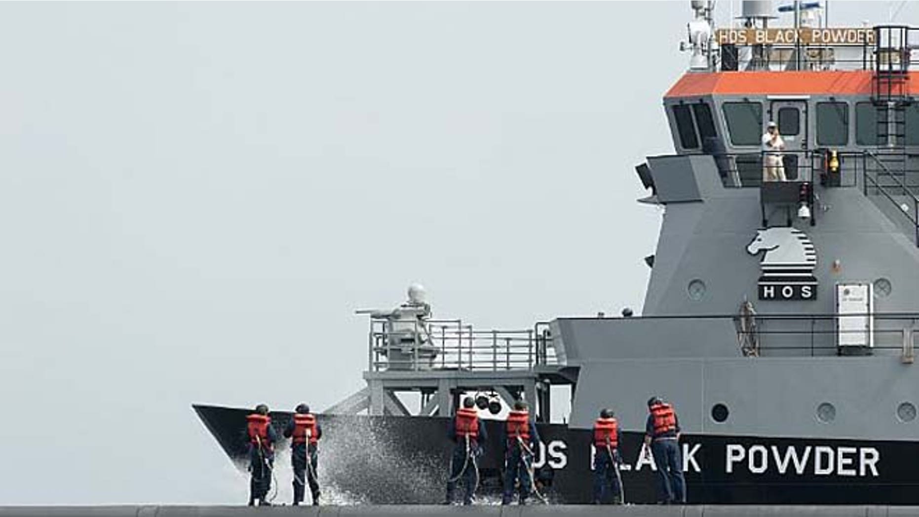 In a June 6, 2012, file photo, crew members from the ballistic-missile submarine USS Wyoming wait topside for a personnel transfer of a group of midshipmen from the U.S. Naval Academy. (U.S. Navy photo by Mass Communication Specialist 1st Class James Kimber/Released)