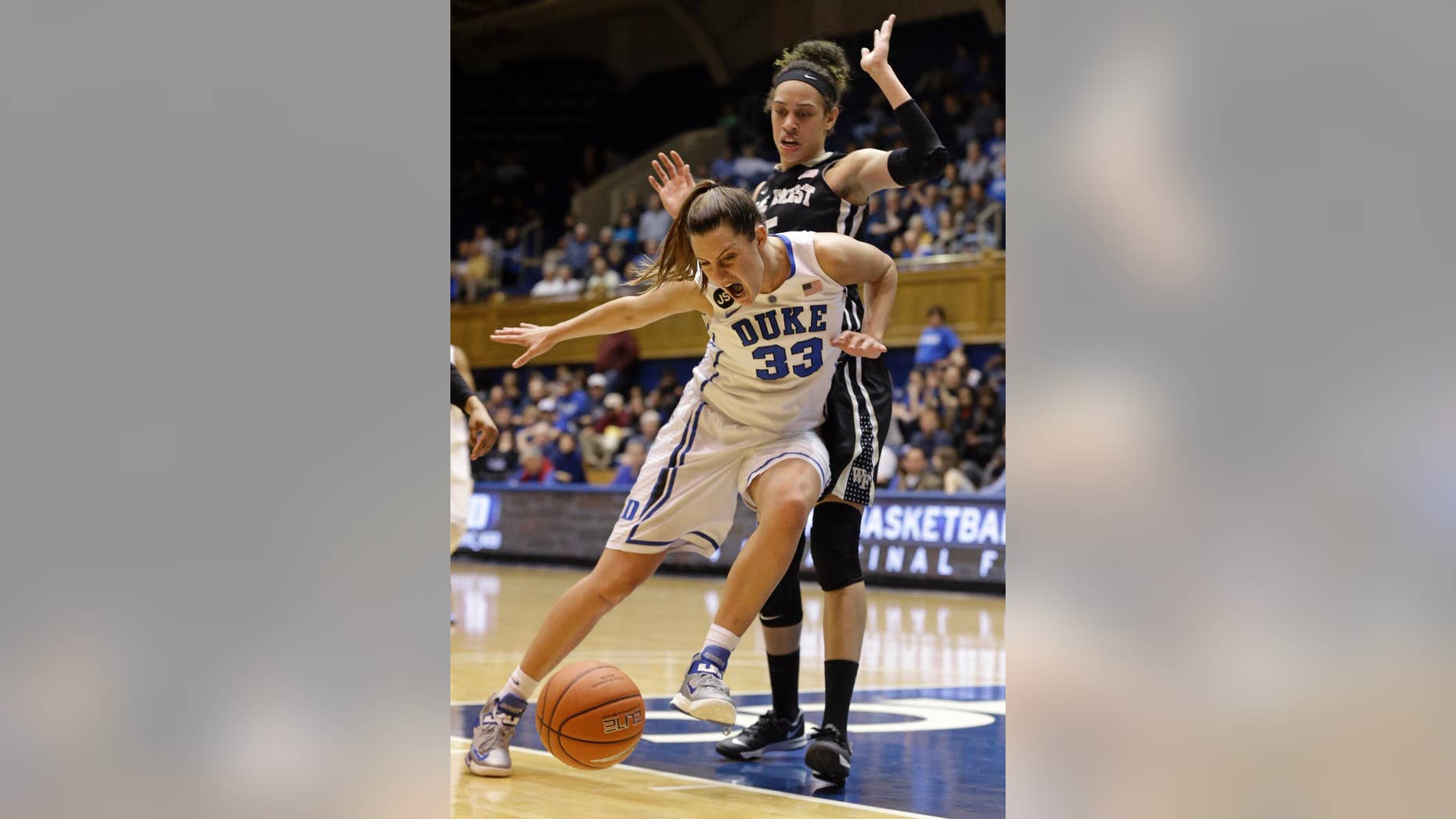 Duke's Haley Peters (33) loses the ball as Wake Forest's Dearica Hamby defends during the first half of an NCAA college basketball game in Durham, N.C., Thursday, Feb. 27, 2014. (AP Photo/Gerry Broome)