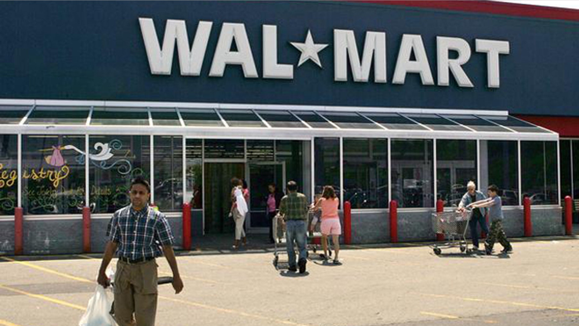 Shoppers enter and exit a Wal-Mart, in Walpole, Mass., Wednesday, May 11, 2005. Wal-Mart Stores Inc. reported a 14 percent increase in first-quarter earnings Thursday, May 12, 2005, but the results missed Wall Street estimates. The world's largest retailer also warned that second-quarter results would likely be lower than expected. (AP Photo/Steven Senne)