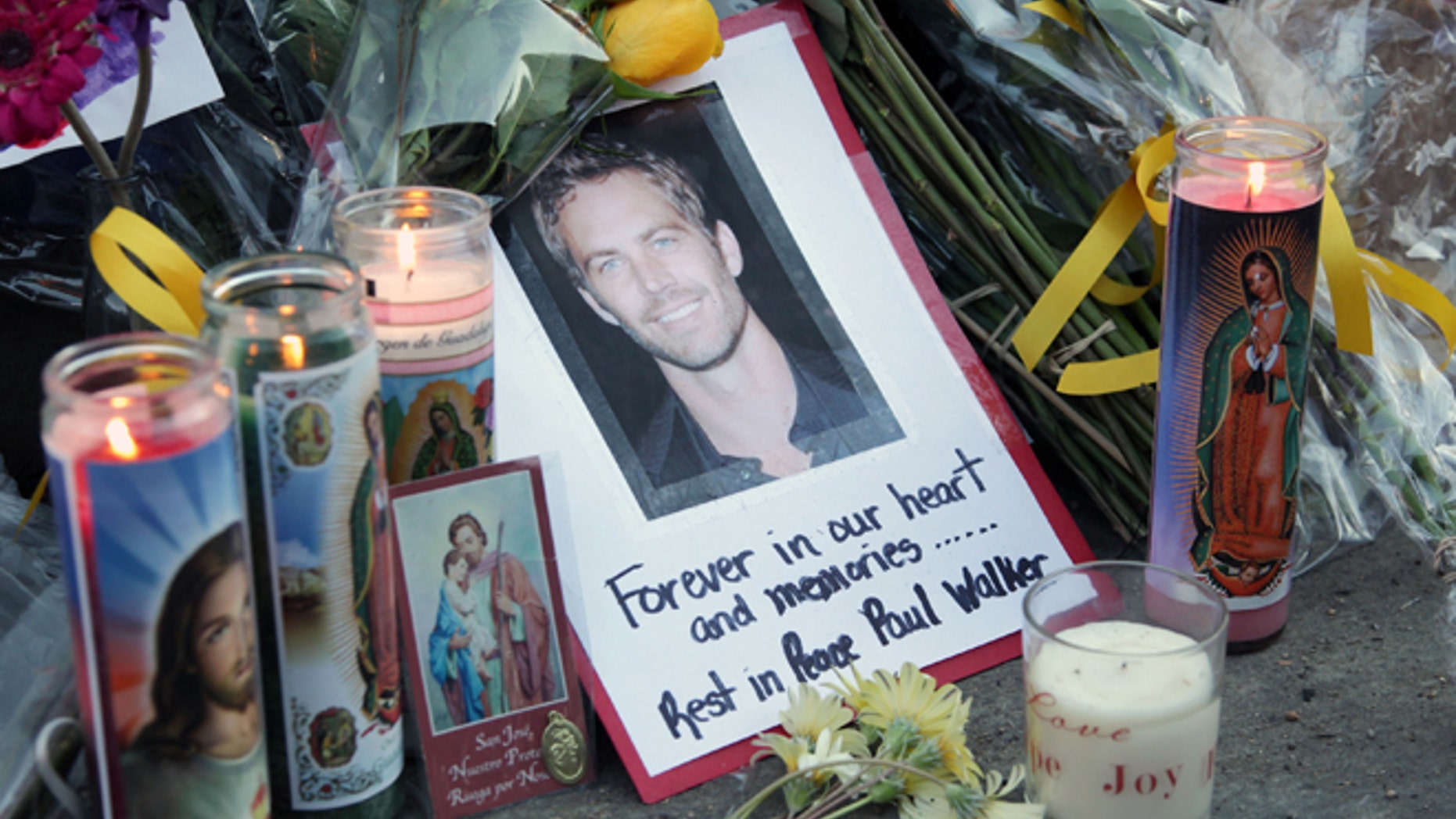 VALENCIA, CA - DECEMBER 01: A general view of atmosphere as fans pay tribute to actor Paul Walker at the site of his fatal car accident on December 1, 2013 in Valencia, California. Walker died on November 30, 2013 at age 40. (Photo by David Buchan/Getty Images)