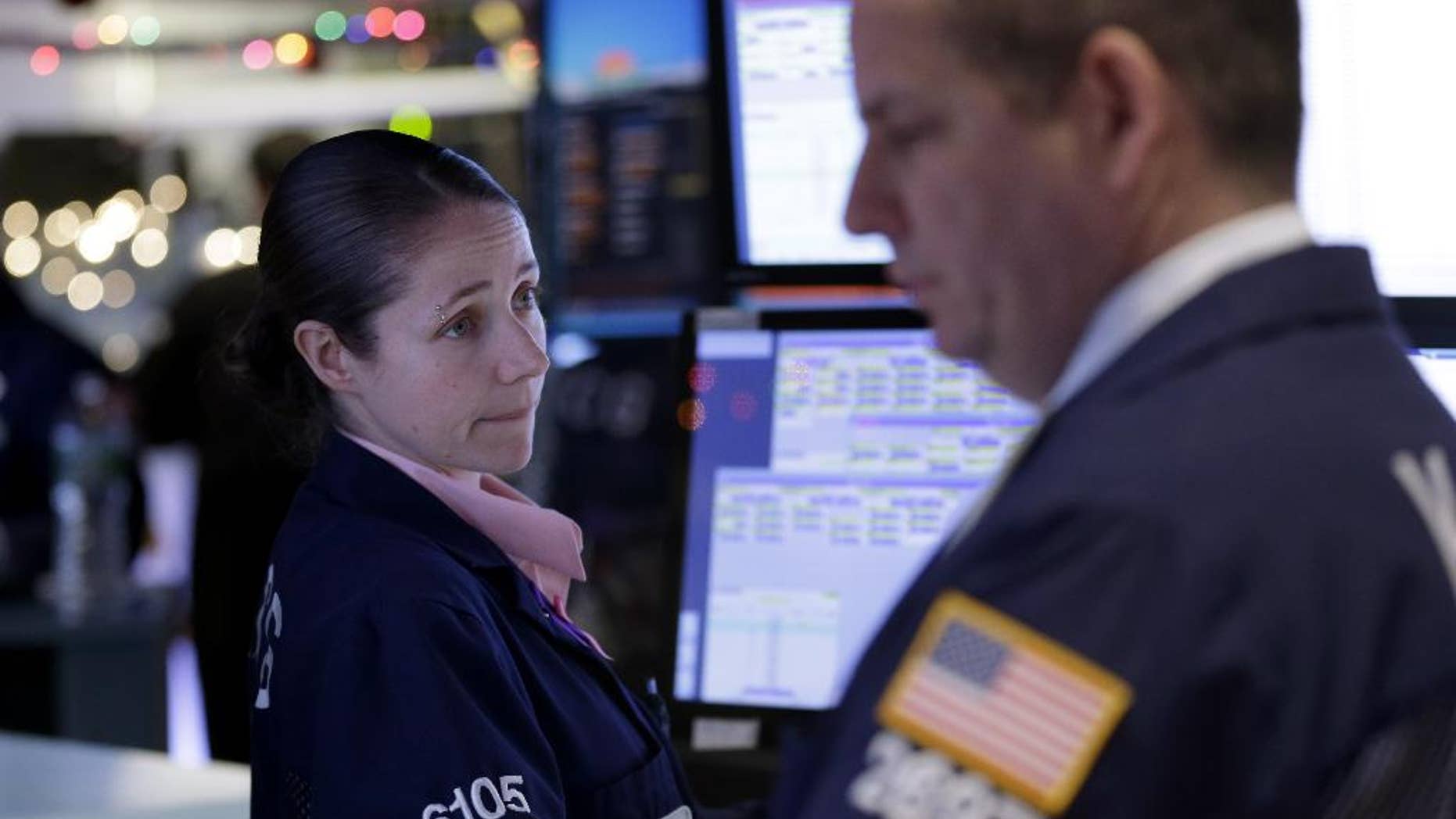 Traders work on the floor at the New York Stock Exchange in New York, Thursday, Dec. 18, 2014. The market is opening sharply higher, building on gains from the day before after the Federal Reserve indicated it was in no rush to raise interest rates. (AP Photo/Seth Wenig)