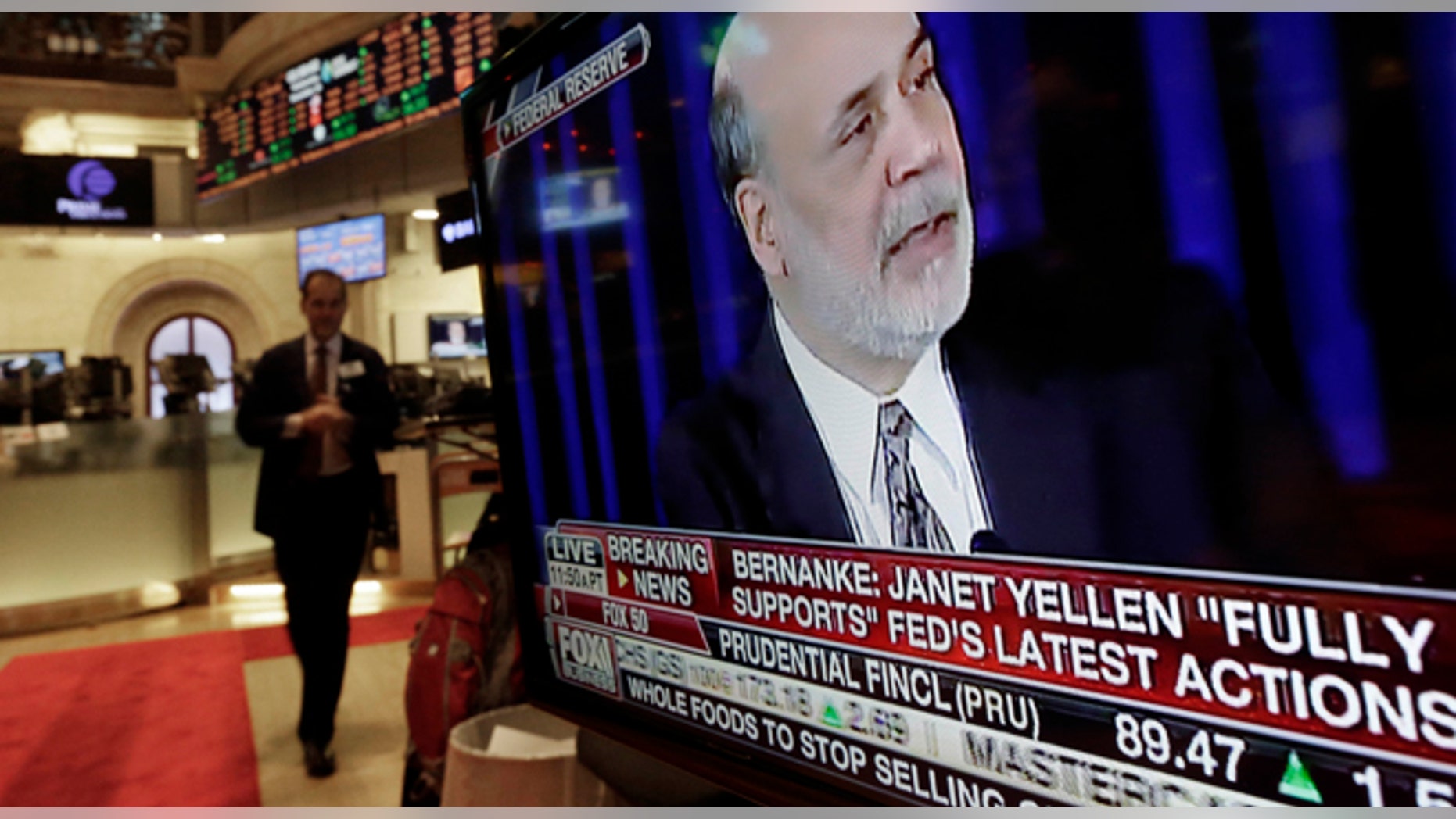 The news conference of Federal Reserve Chairman Ben Bernanke appears on a television screen at a trading post on the floor of the New York Stock Exchange, Wednesday, Dec. 18, 2013. The Federal Reserve has decided to reduce its stimulus for the U.S. economy because the job market has shown steady improvement. The Fed will trim its $85 billion a month in bond purchases by $10 billion starting in January. (AP Photo/Richard Drew)