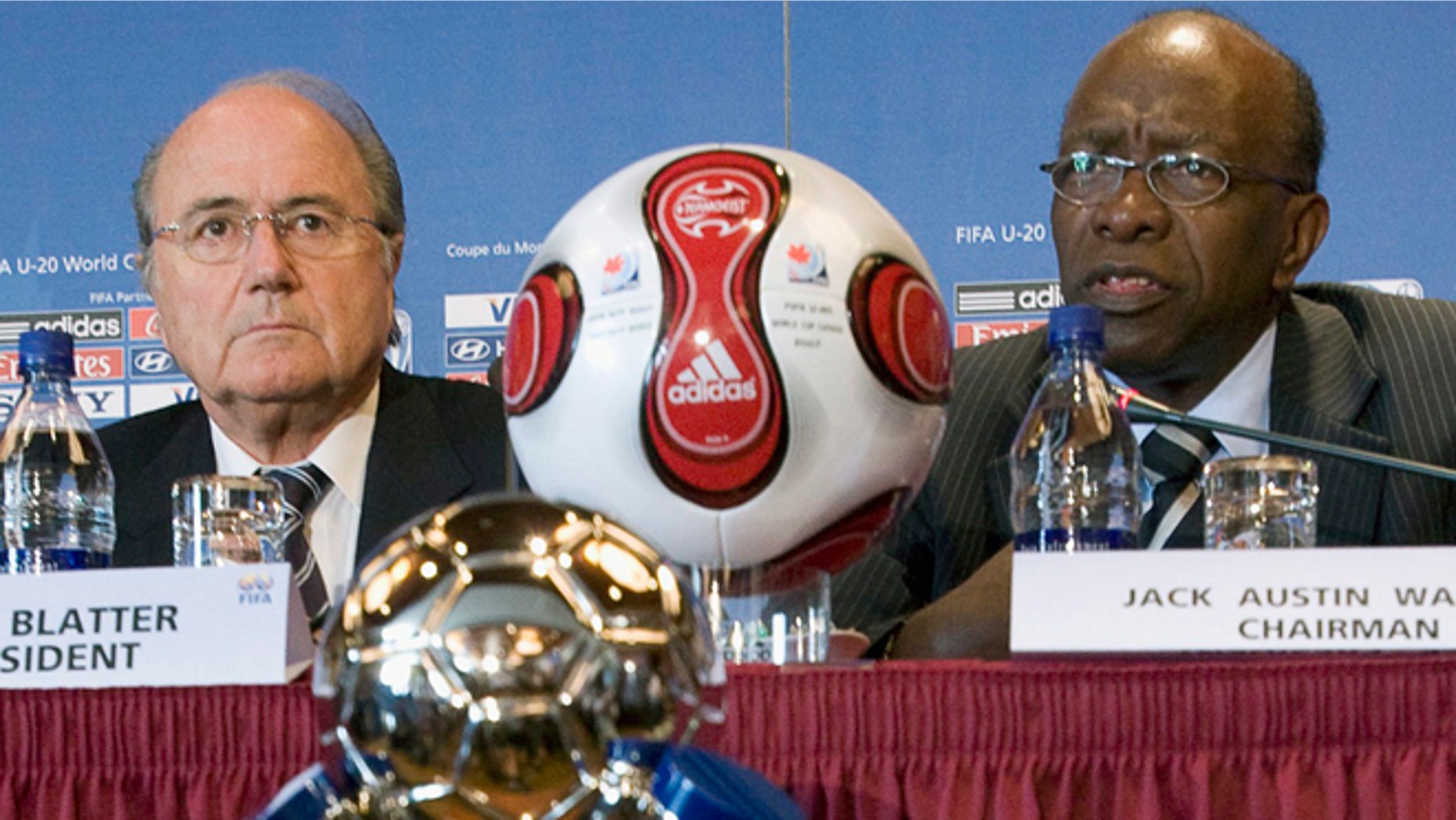 FILE - In this July 20, 2007 file photo Joseph "Sepp" Blatter, left, president of FIFA, listens to Jack Warner, chairman of the tournament during a news conference as part of the FIFA U-20 World Cup in Toronto, Canada. FIFA said Tuesday, Sept. 29, that Warner will be banned for life from soccer related activities. (Paul Chiasson, CP via AP, file)