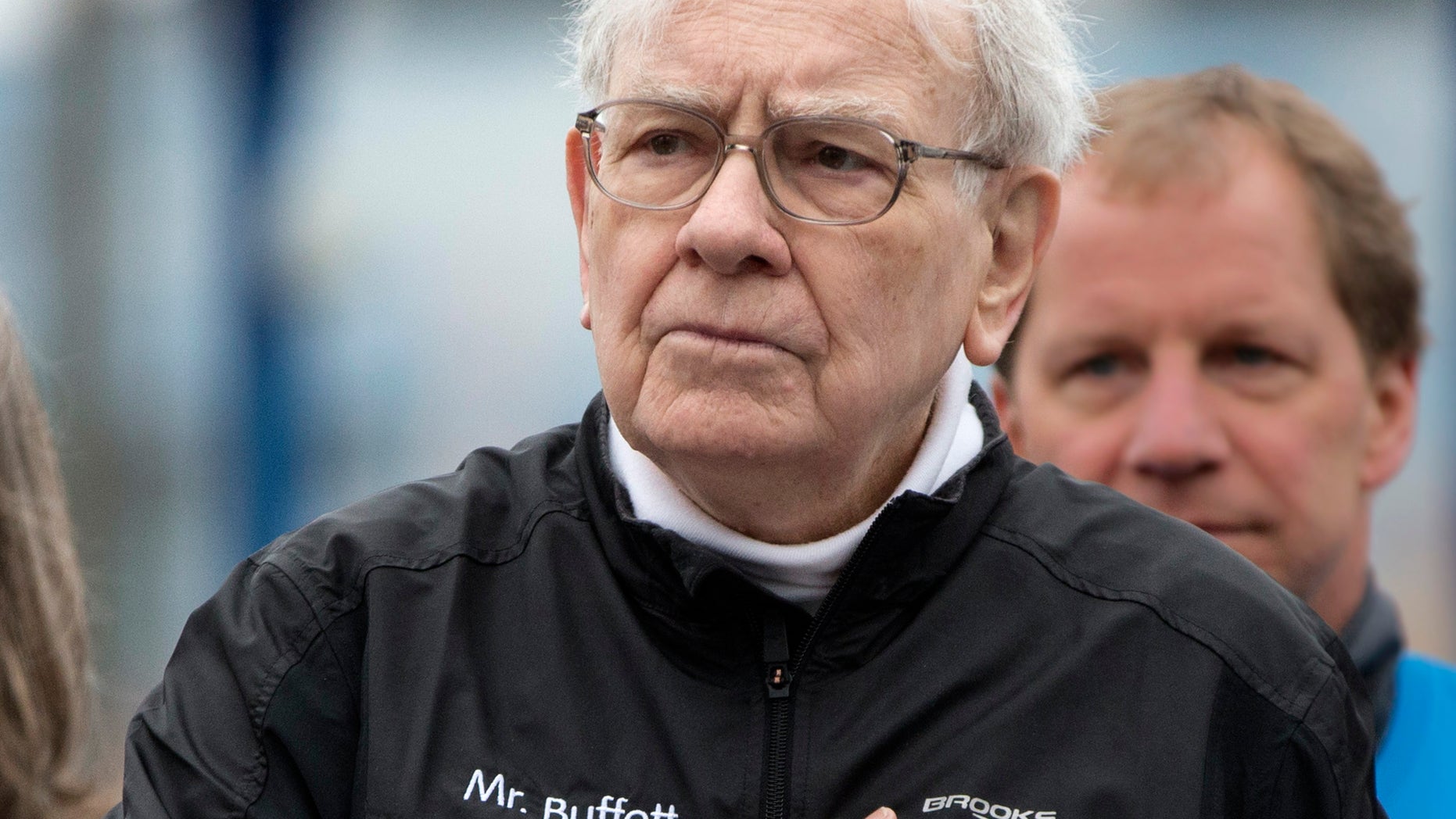 Investor Warren Buffett places a hand on his heart during the playing of the national anthem prior to launching a 5K run and walk organized by the Brooks Running Company, a Berkshire Hathaway subsidiary, in Omaha, Neb., Sunday, May 5, 2013. The Berkshire Hathaway shareholders meeting is being held this weekend in Omaha. (AP Photo/Nati Harnik)