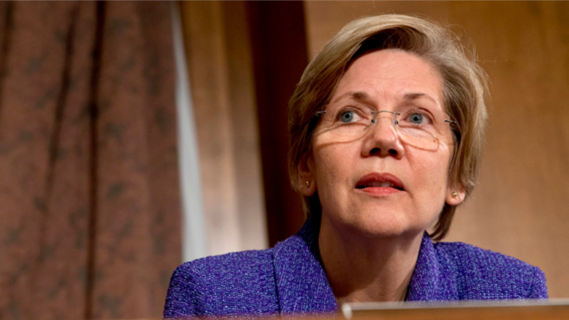 FILE: Tuesday Nov. 12, 2013: Senate Banking Committee member Sen. Elizabeth Warren, D- Mass. listens to testimony on Capitol Hill, in Washington, D.C.