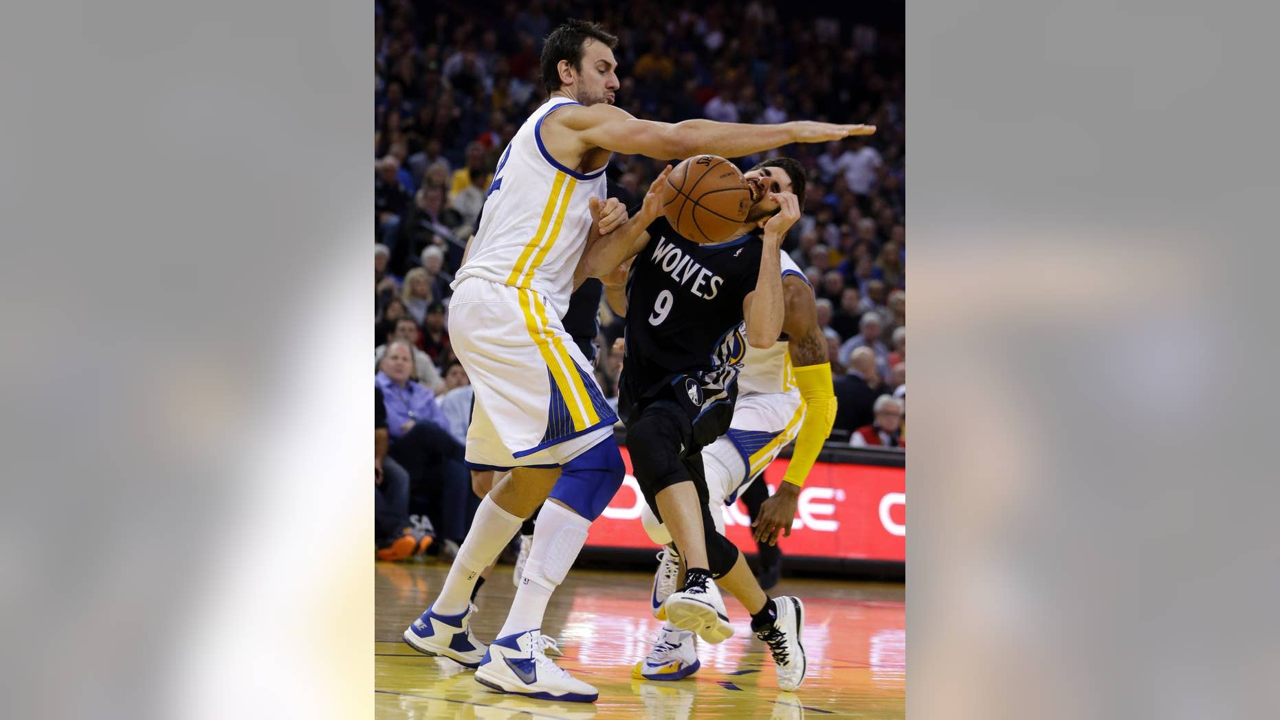 FILE - IN this Jan. 24, 2014, file photo, Golden State Warriors' Andrew Bogut, left, blocks Minnesota Timberwolves' Ricky Rubio during an NBA basketball game in Oakland, Calif. The Warriors will likely be without Bogut when they begin the playoffs this weekend. The loss of Bogut, who has a fractured right rib, leaves the Warriors without their best interior defender. (AP Photo/Ben Margot, File)