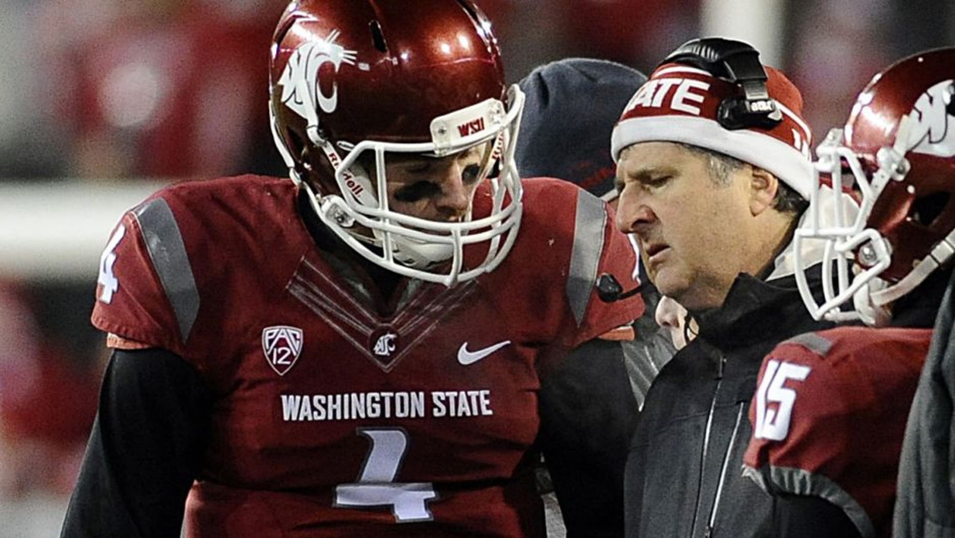 Nov 29, 2014; Pullman, WA, USA; Washington State Cougars head coach Mike Leach talks with quarterback Luke Falk (4) during a game against the Washington Huskies during the second half at Martin Stadium. Huskies won 31-13. Mandatory Credit: James Snook-USA TODAY Sports