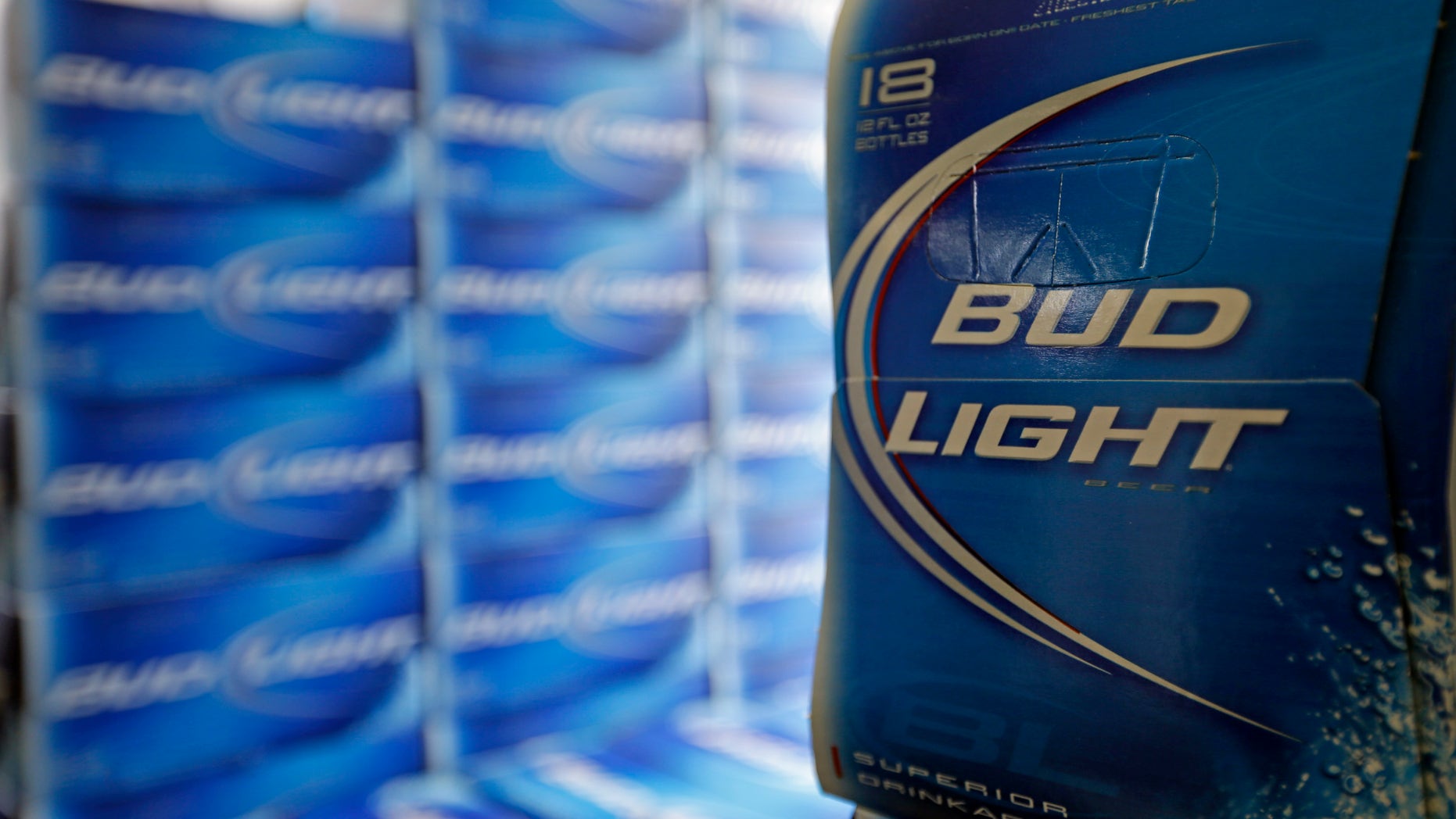 Jan. 28, 2013: File photo, Bud Light beer is shown in the aisles of Elite Beverages in Indianapolis. Beer lovers across the country have filed $5 million class-action lawsuits accusing Anheuser-Busch of watering down its Budweiser, Michelob and other brands.