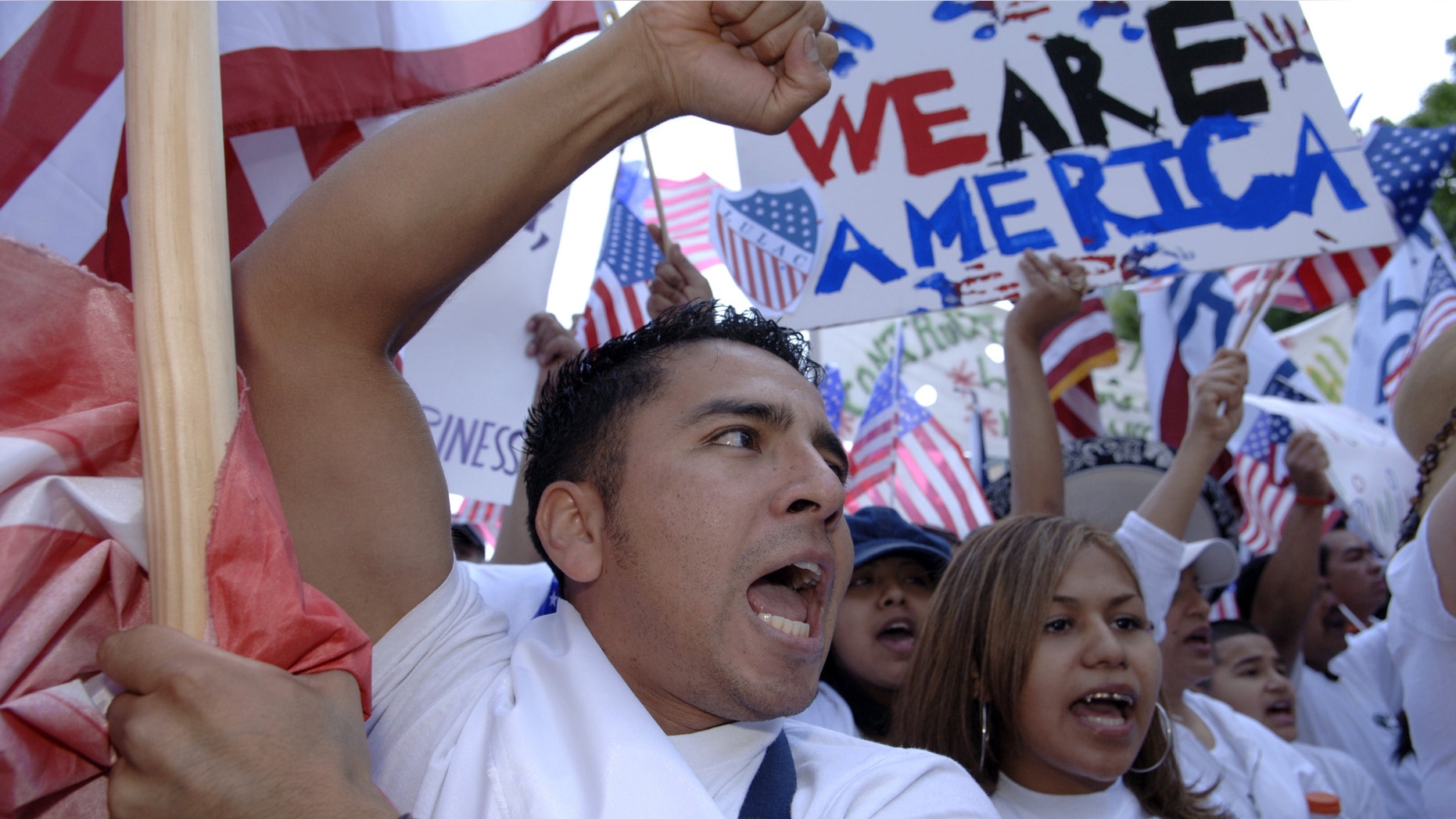 DALLAS - APRIL 9: Juan R. Ramirez gestures as he leads the front of the Mega March protest on City Hall April 9, 2006 in Dallas, Texas. According to reports, an estimated half million Hispanics participated in the Mega March to peacefully protest immigration reform. (Photo by Jensen Walker/Getty Images)