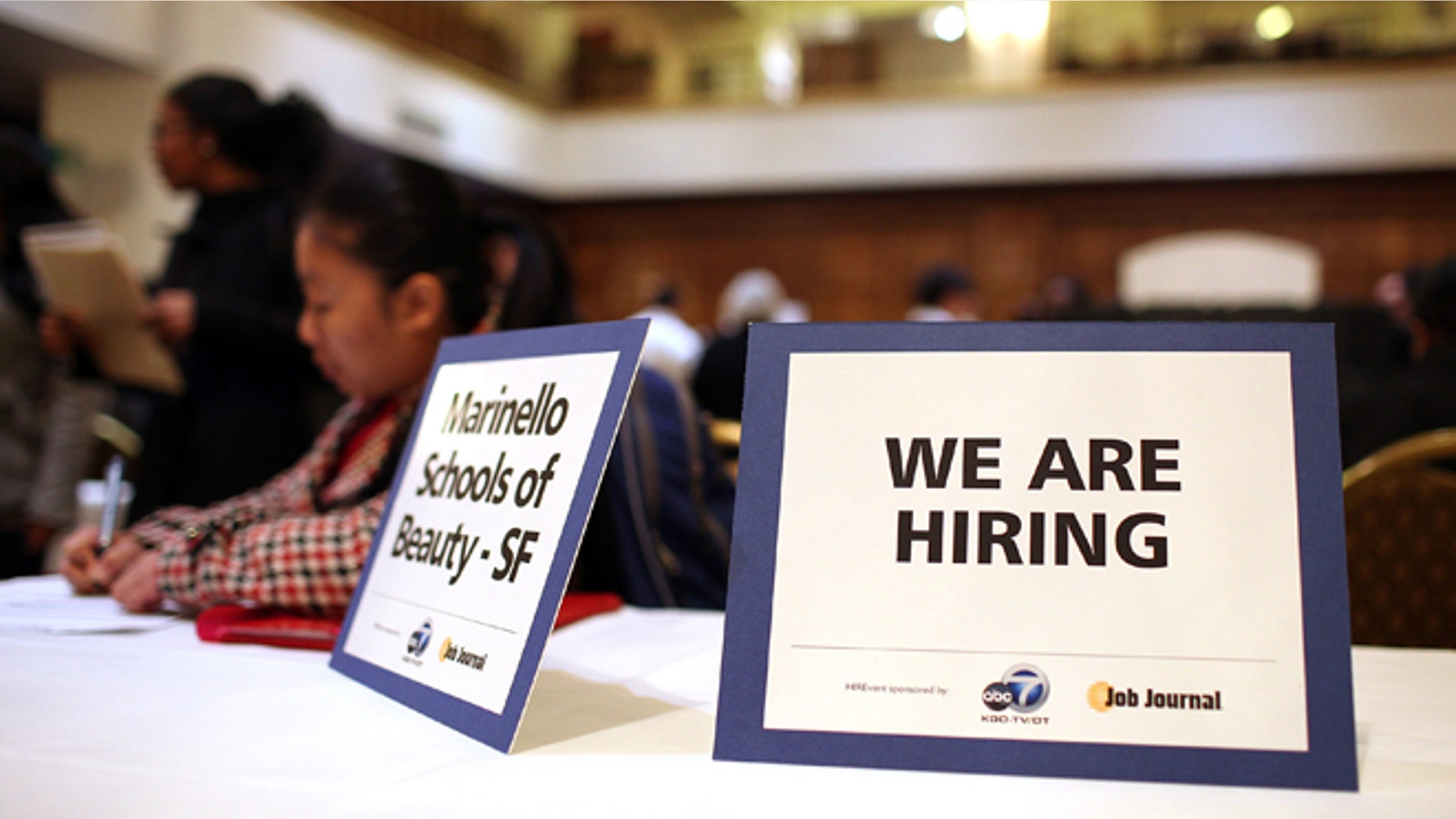 SAN FRANCISCO, CA - MARCH 27: A "we are hiring" sign is displayed on a table during the San Francisco Hirevent job fair at the Hotel Whitcomb on March 27, 2012 in San Francisco, California. As the national unemployment rate stands at 8.3 percent, job seekers turned out to meet with recruiters at the San Francisco Hirevent job fair where hundreds of jobs were available. (Photo by Justin Sullivan/Getty Images)