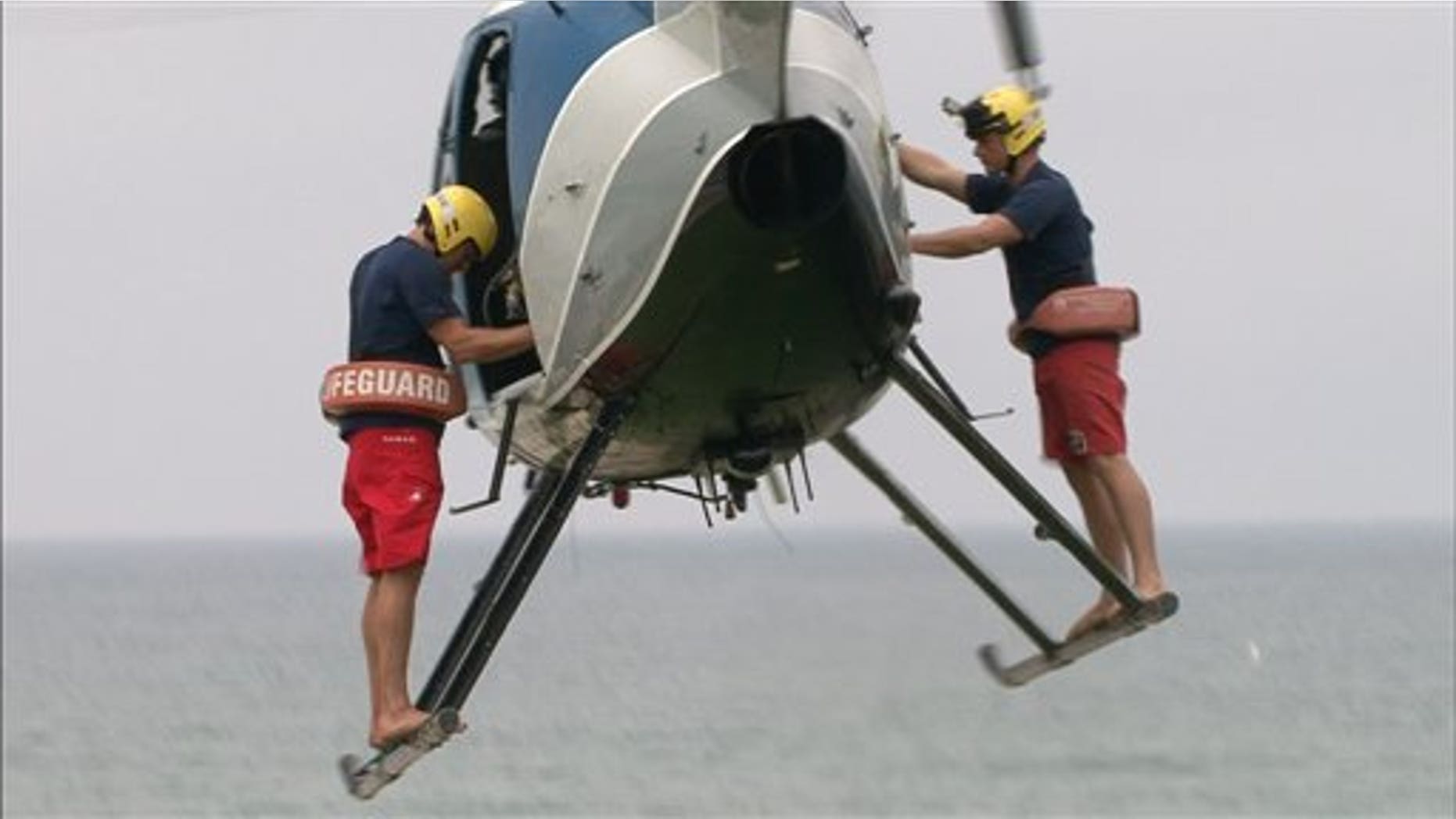 In this undated image released by The Weather Channel, two lifeguards prepare to make a rescue in a scene from ""Lifeguard!," about beach rescuers in southern California.