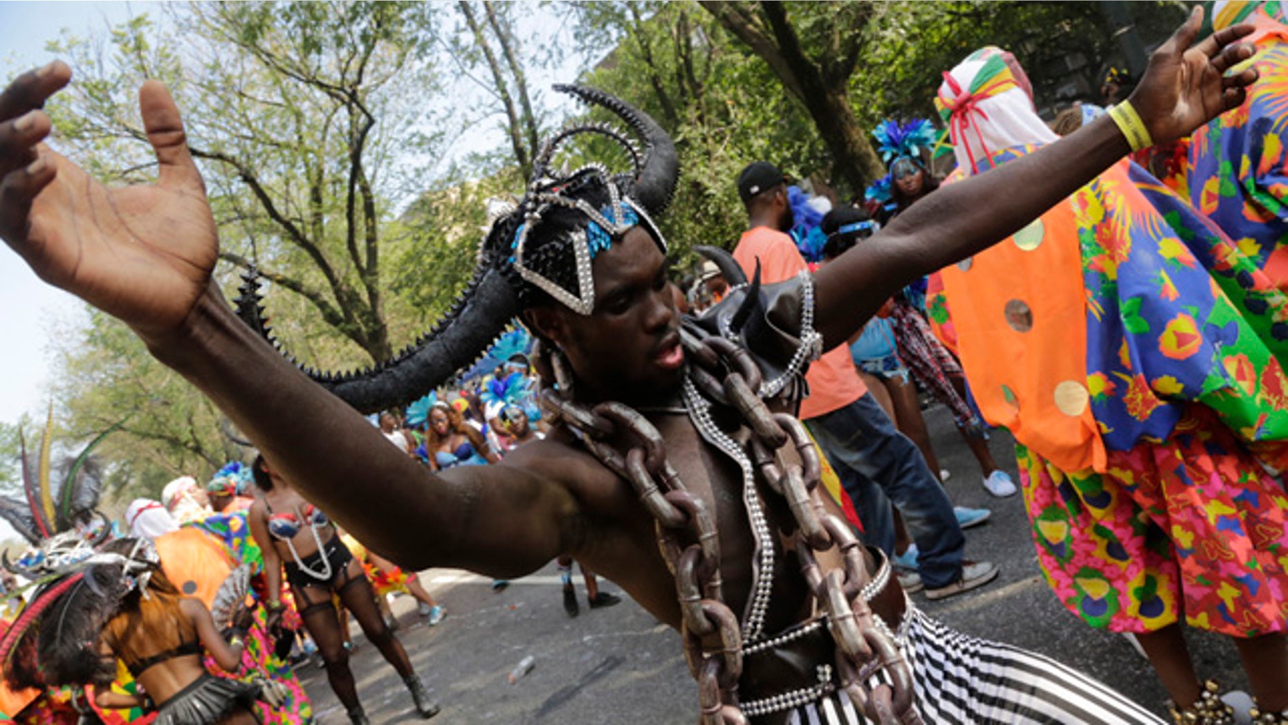 September 1, 2014: A dancer performs for spectators during the West Indian Day Parade in the Brooklyn borough of New York. (AP Photo/Mark Lennihan)