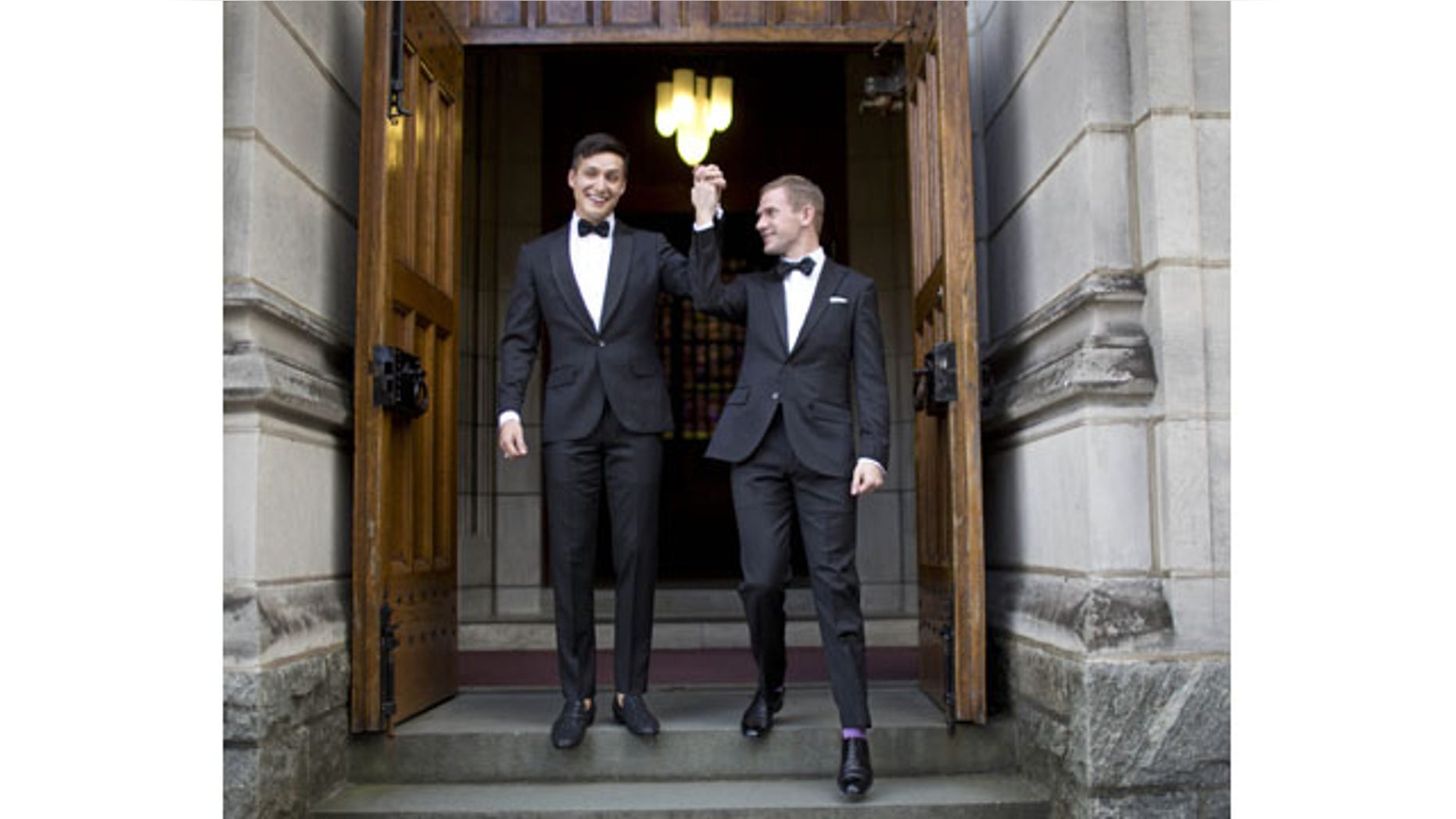 November 2, 2013: West Point graduate Larry Lennox-Choate, left, and Daniel Lennox-Choate, leave church following their wedding ceremony on Saturday, Nov. 2, 2013, at the U.S. Military Academy's Cadet Chapel in West Point, N.Y. Choate and Lennox are the first men to wed at the chapel since New York legalized gay marriage in 2012. The chapel has already hosted two same-sex weddings of women in late 2012. (AP Photo/Jill Knight)
