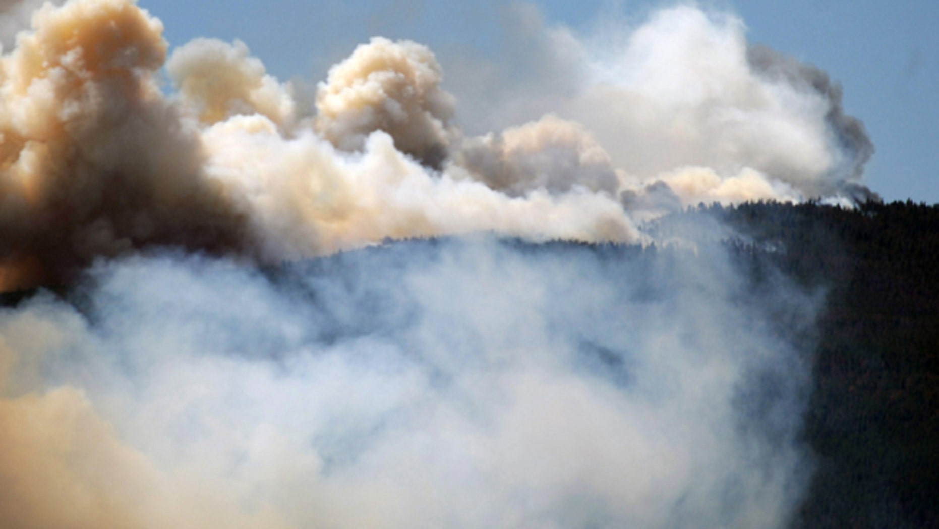 June 12, 2012: Smoke billows from a wildfire burning west of Fort Collins, Colo.