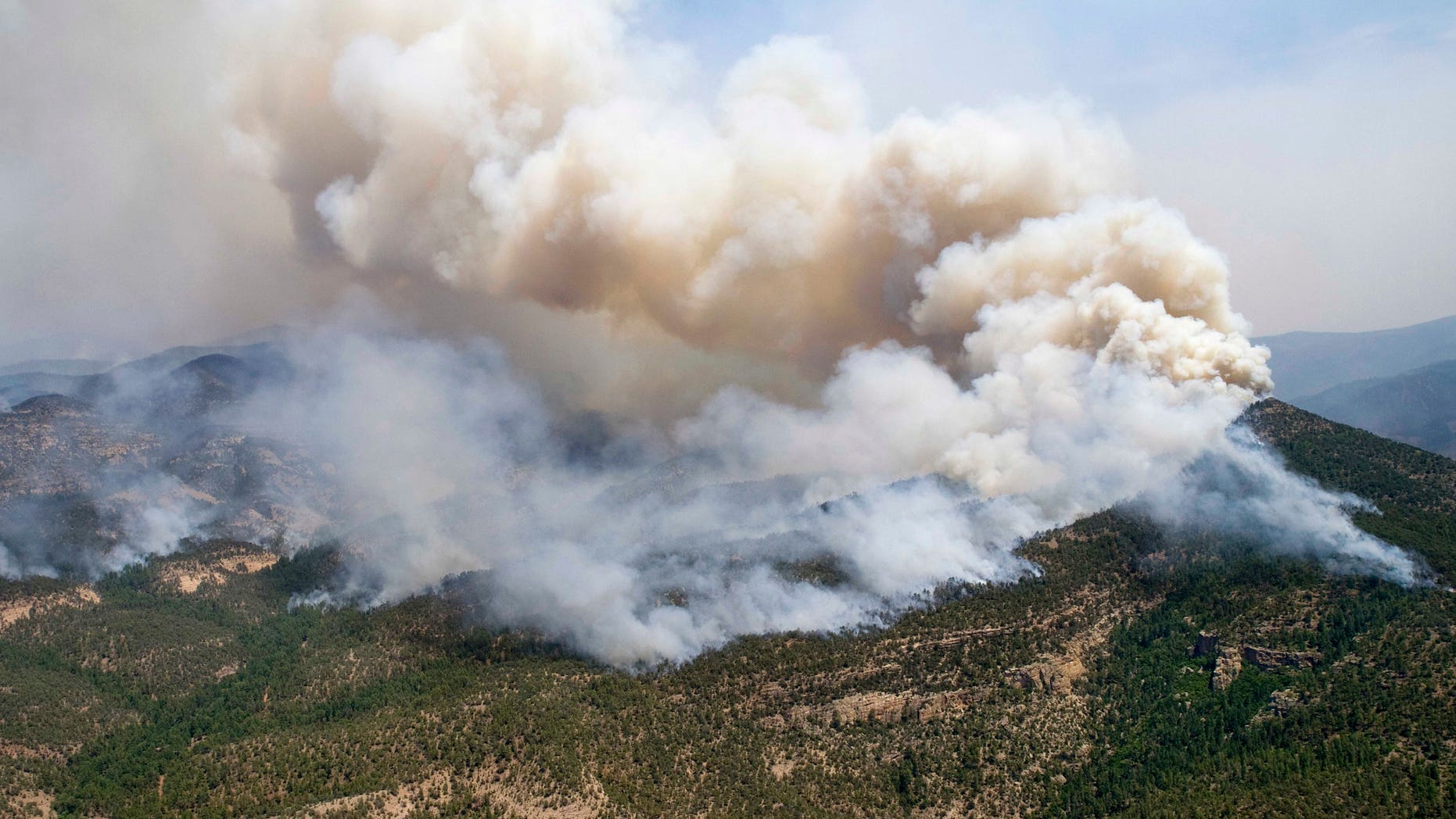 June 2, 2012: A large cloud of smoke rises from a fire in the Gila National Forest in New Mexico. The Whitewater-Baldy Complex fire has scorched more than 377 square miles.