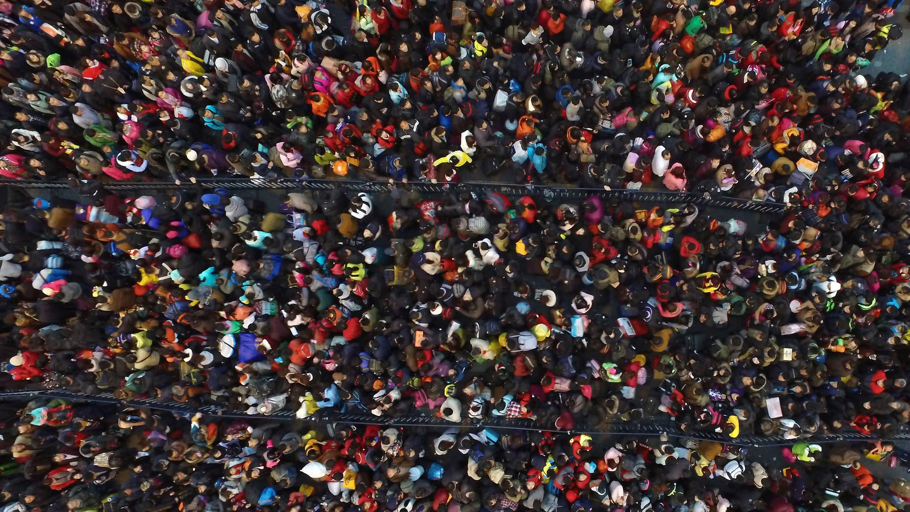 Stranded passengers wait outside the Guangzhou Railway Station after trains were delayed in Guangzhou on Tuesday.