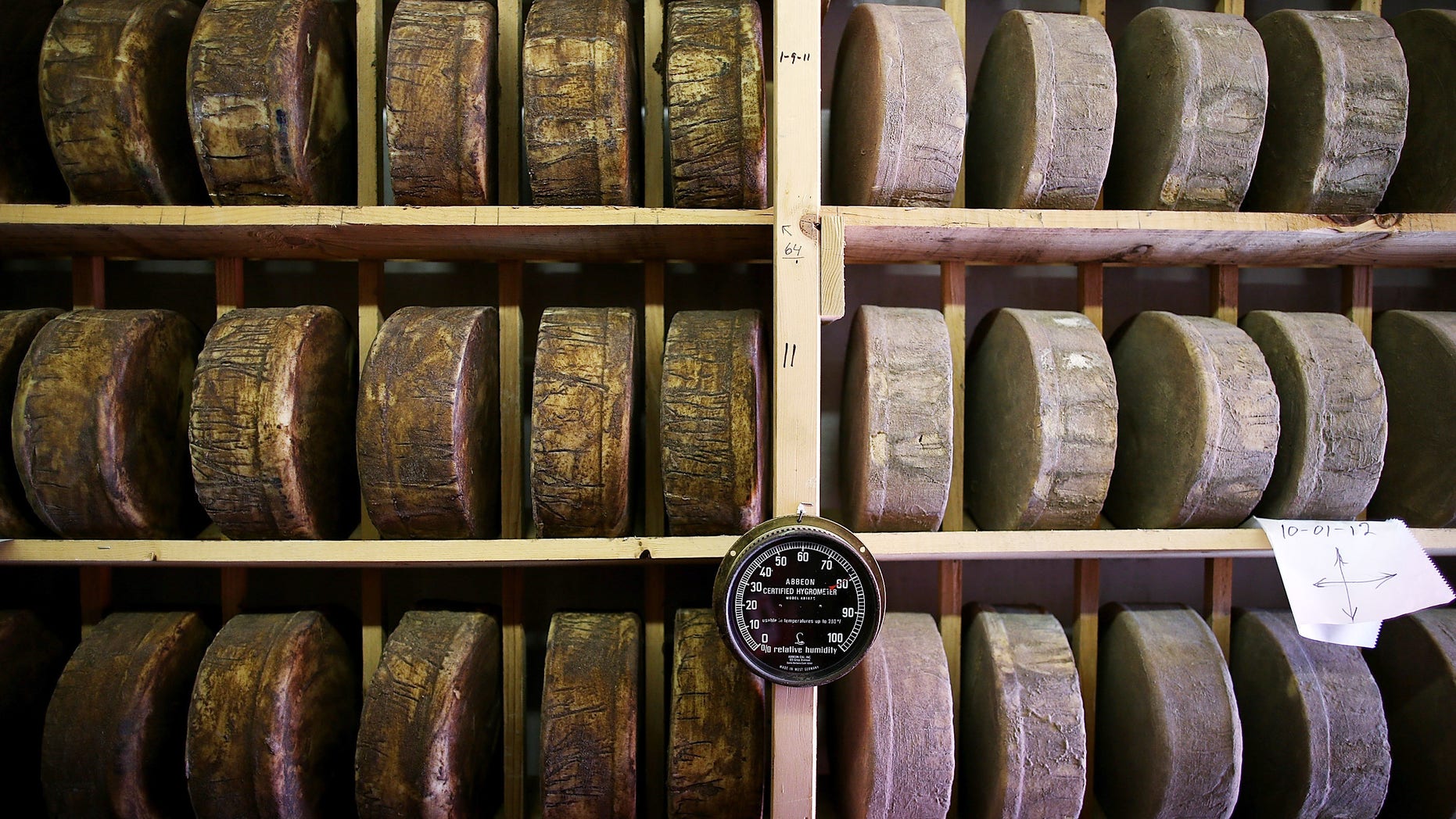 SONOMA, CA - JUNE 10: Wheels of jack cheese age on wooden racks in a cooler at Vella Cheese on June 10, 2014 in Sonoma, California. The Food and Drug Administration (FDA) has issued an executive decree to ban the use of wooden boards to age cheese, a move that could be a huge blow to artisan cheesamkers who use wooden racks to age their non-processed cheese. (Photo by Justin Sullivan/Getty Images)