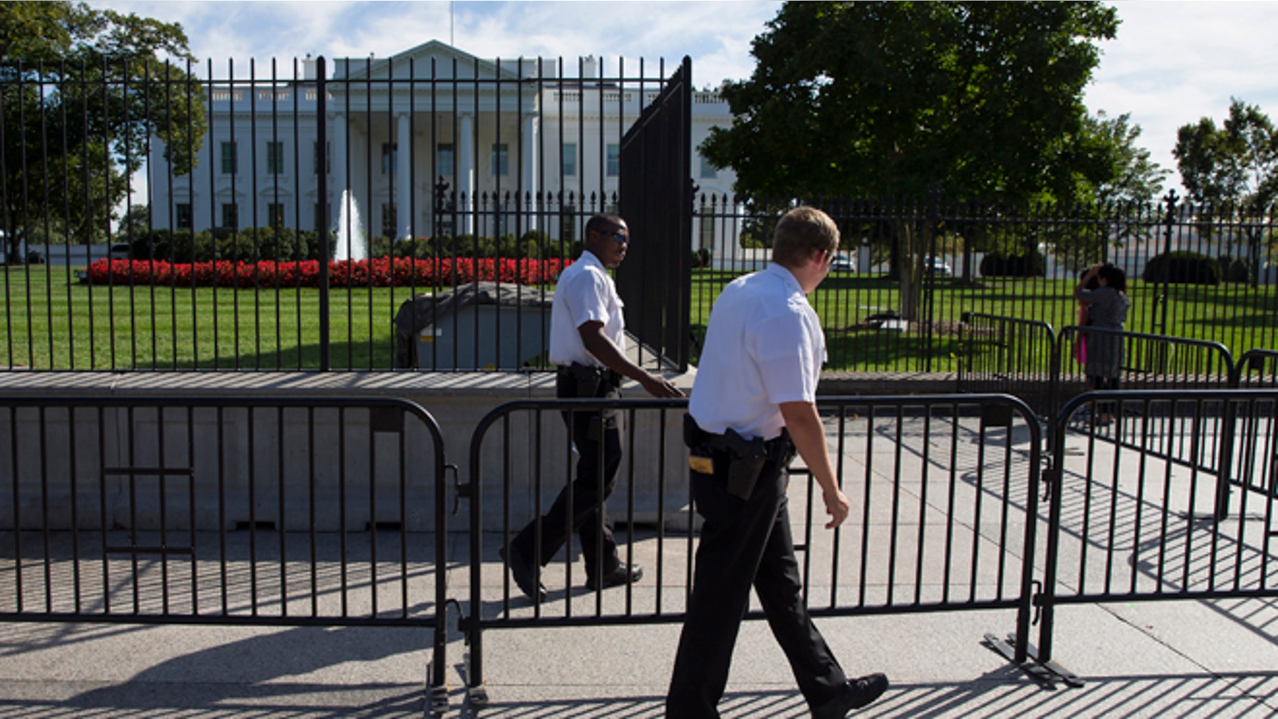 In this Monday, Sept. 22, 2014 photo, Secret Service police officers walk outside the White House in Washington.