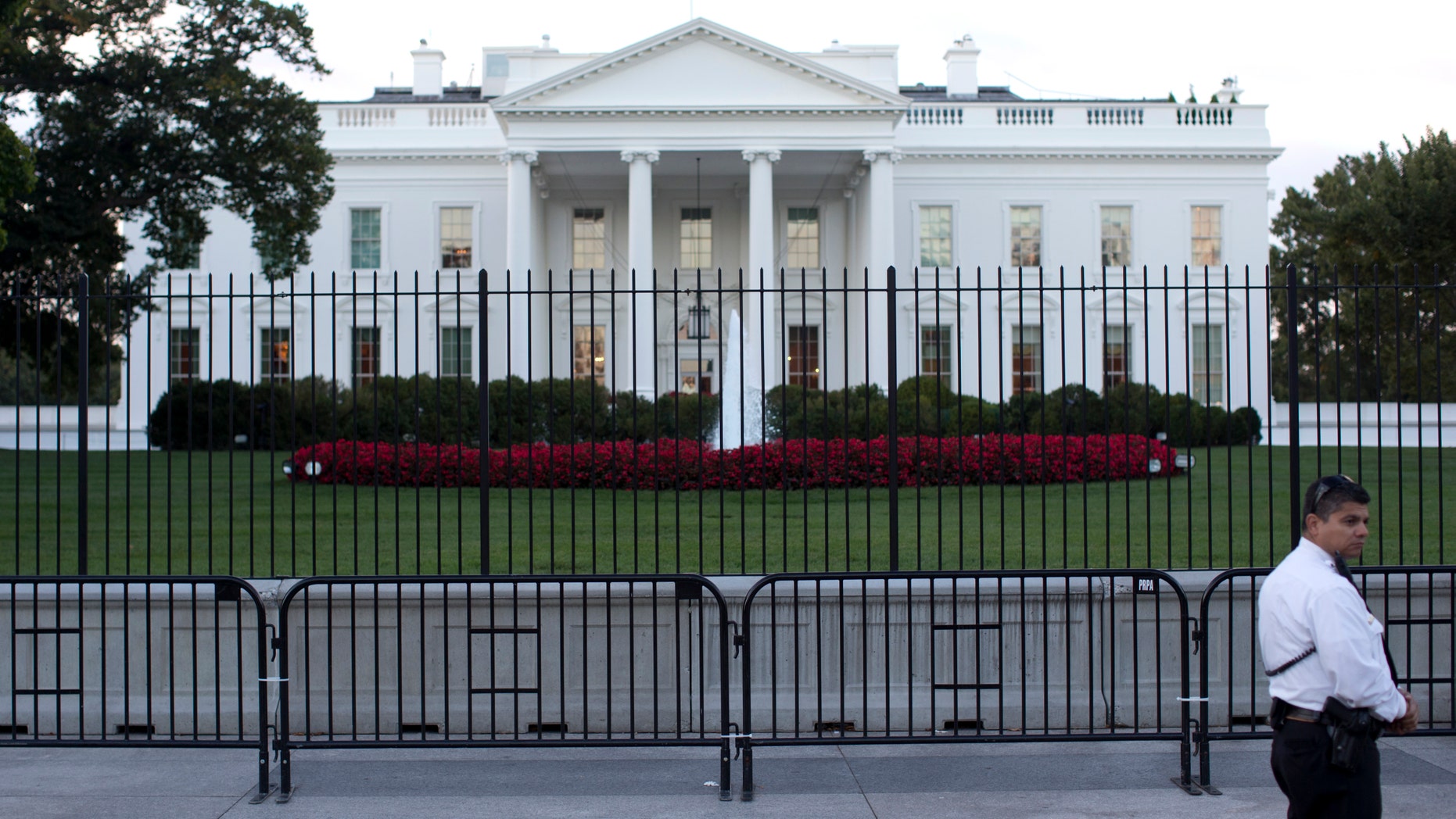 The White House is seen through two layers of fence in Washington, Tuesday, Sept. 23, 2014.