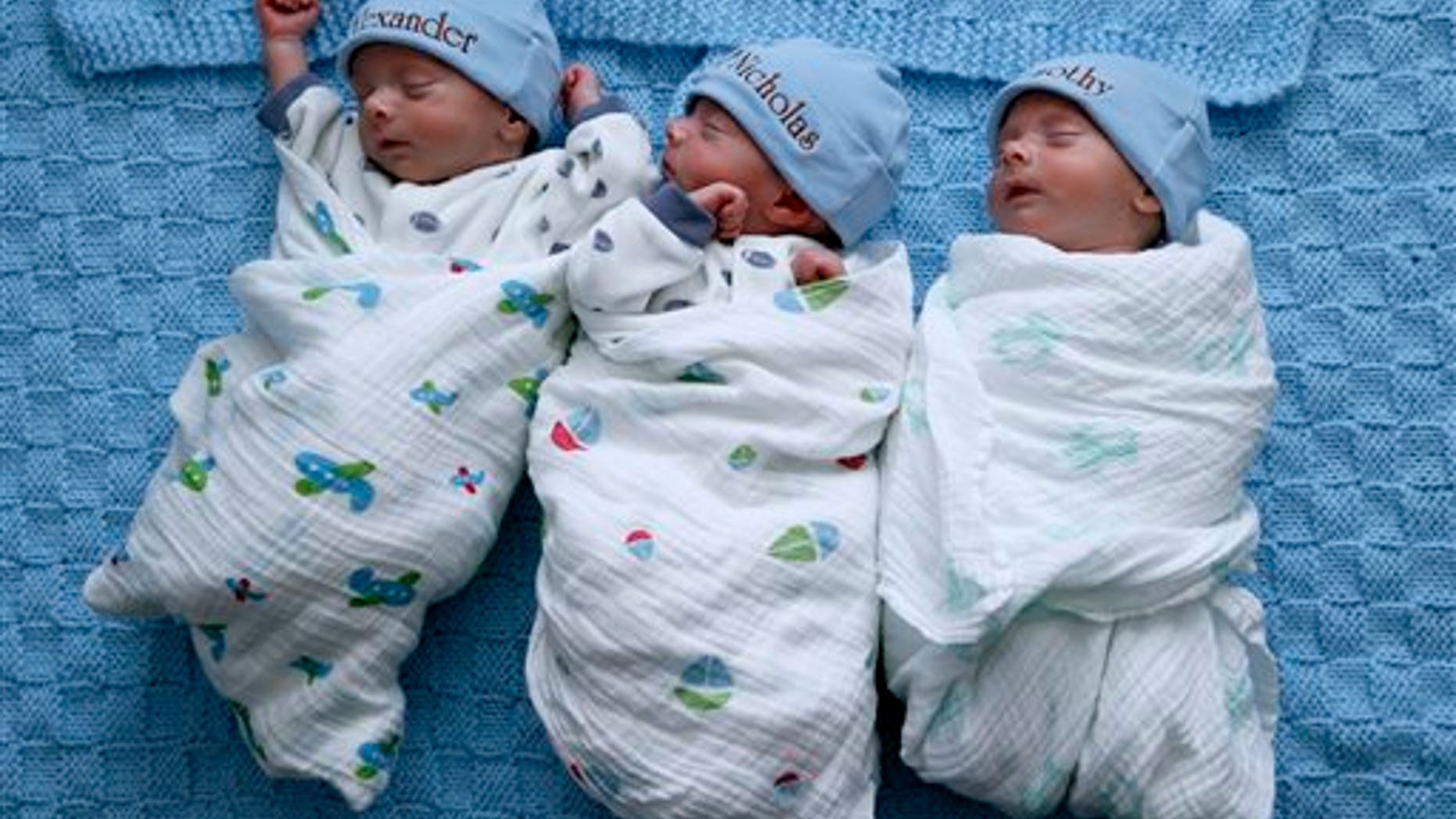 Identical triplets Alexander, Nicholas and Timothy Whiteley, left to right, sleep at their home in St. Clair Shores, Mich., Wednesday, Feb. 25, 2015. (AP Photo/Paul Sancya)