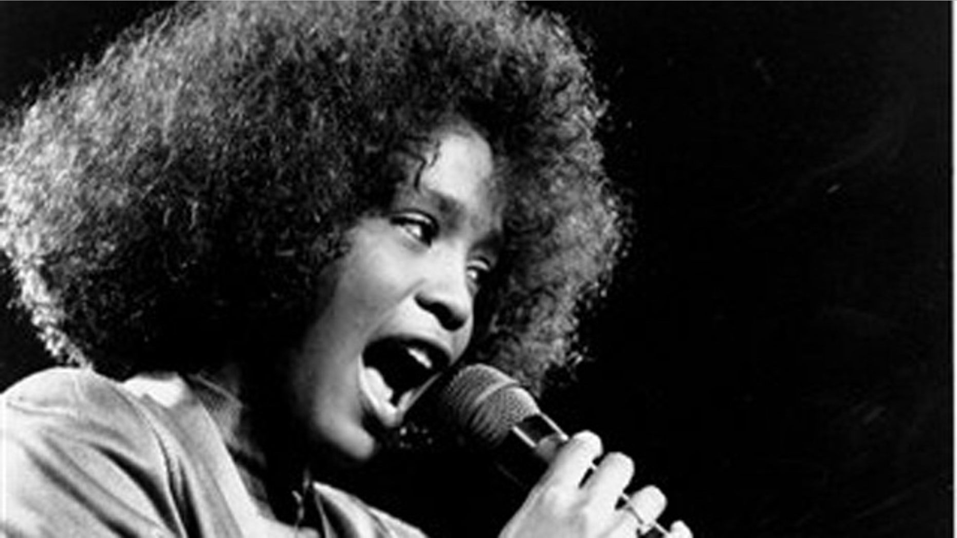 In this May 10, 1986, file photo, American singer Whitney Houston belts out a song during her segment of a benefit concert at Boston Garden. Houston died Saturday, Feb. 11, 2012, she was 48. (AP Photo/Elise Amendola)