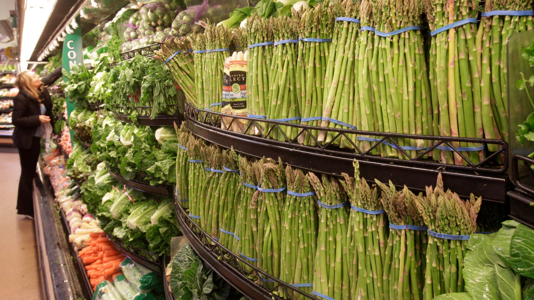 March 1: A customer scans fresh vegetables at a Kroger Co. supermarket in Cincinnati. Wholesale prices jumped last month by the most in nearly two years due to higher energy costs and the steepest rise in food prices in 36 years.