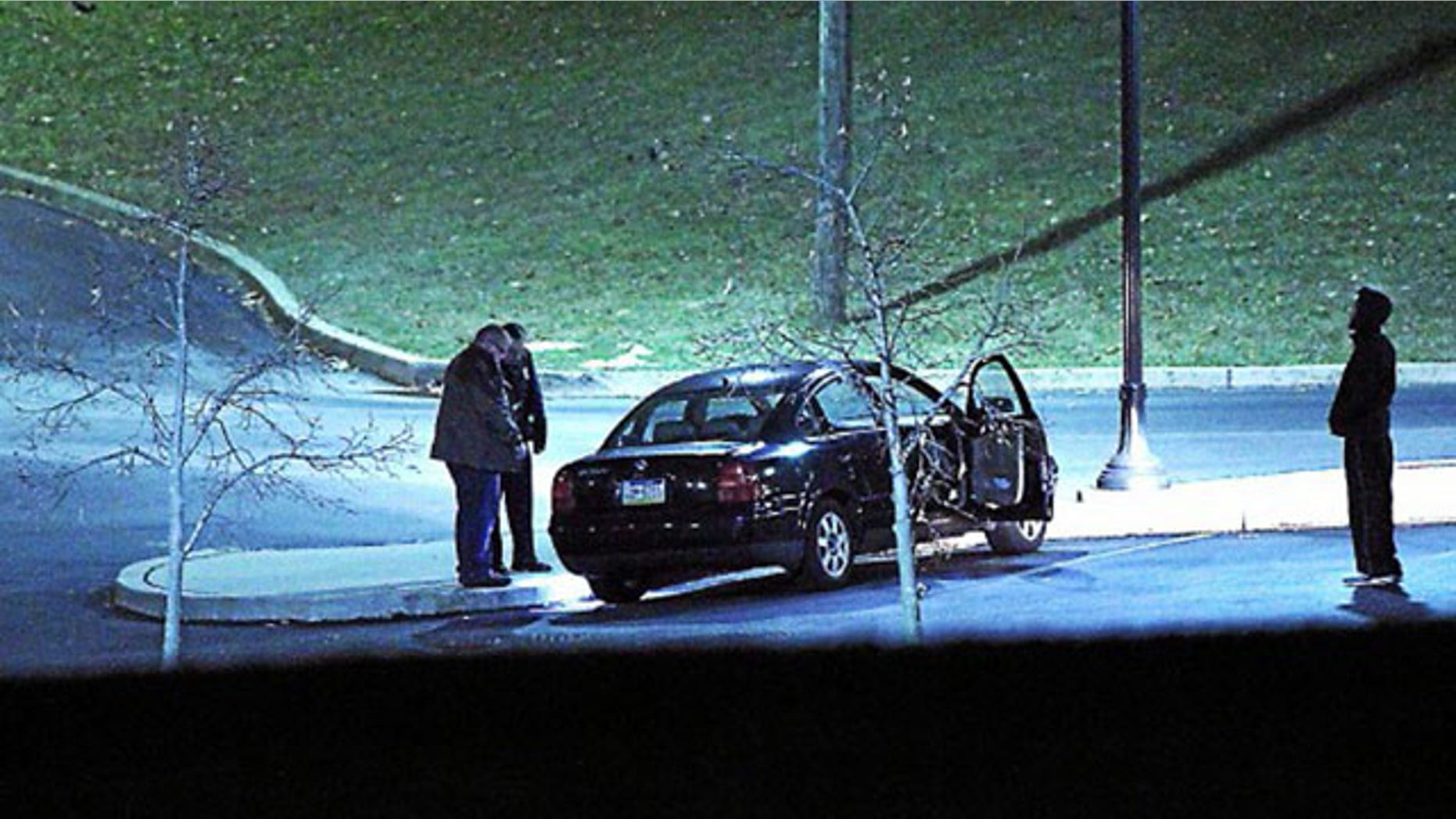 January 20, 2014: Police investigate a car, left, at the athletic center of Widener University in Chester, Pa. after a student was shot. Authorities warned students to remain indoors until further notice. (AP Photo/Delaware County Daily Times, Robert J. Gurecki)