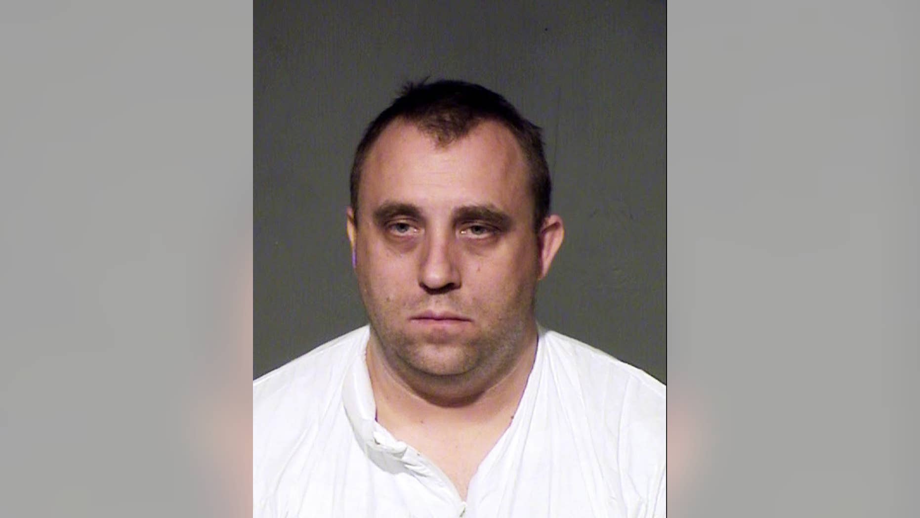 This law enforcement booking photo from the Maricopa County, Ariz., sheriff's office shows John Leo Davis. Police in Goodyear, Ariz., say Davis is accused of fatally stabbing his wife after she confronted him about slapping one of their kids for playing video games. According to police, the couple's seven children were in the family home Thursday, March 26, 2015, when the mother, identified as Michele Davis, 35, was killed. A 14-year-old daughter witnessed the stabbing and called 911. The husband also called 911, reportedly saying he'd lost his mind and stabbed his wife.(AP Photo/Maricopa County Sheriff's Office)