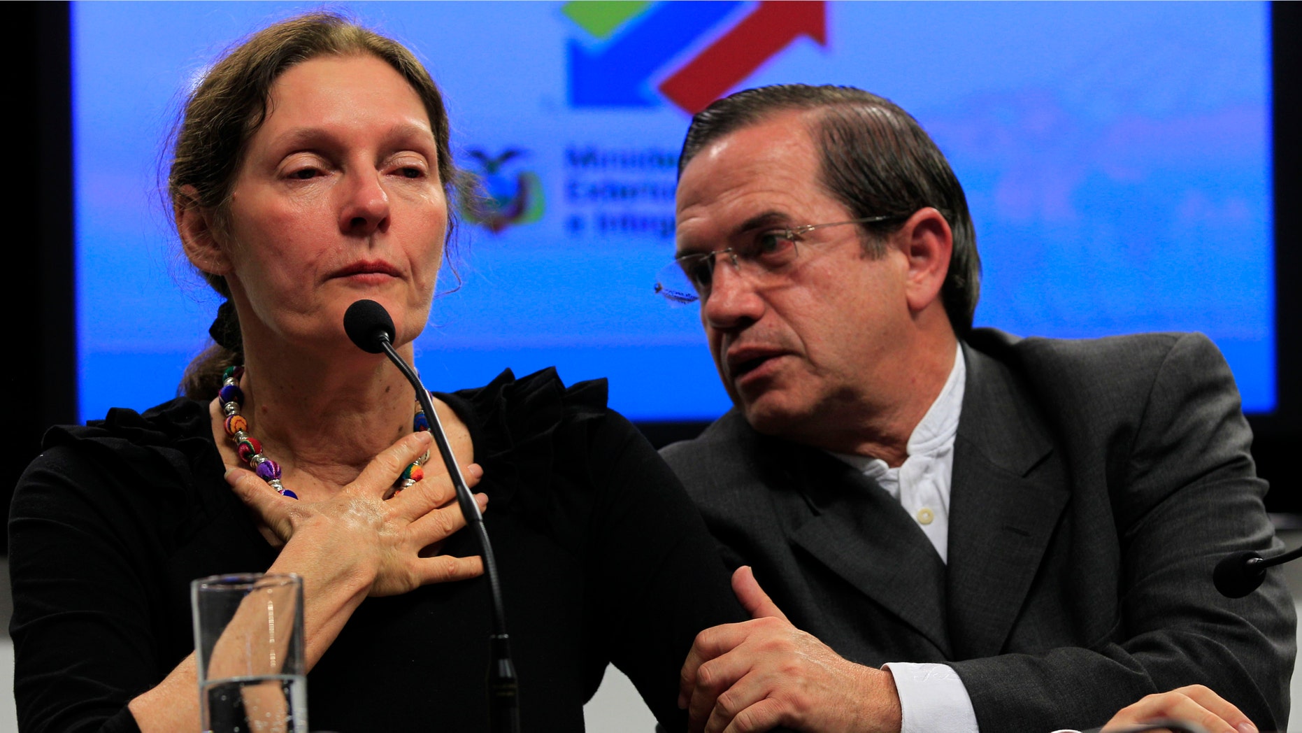 The mother of WikiLeaks founder Julian Assange, Christine Assange, is comforted by Ecuador's Foreign Minister Ricardo Patino during a press conference in Quito, Ecuador.